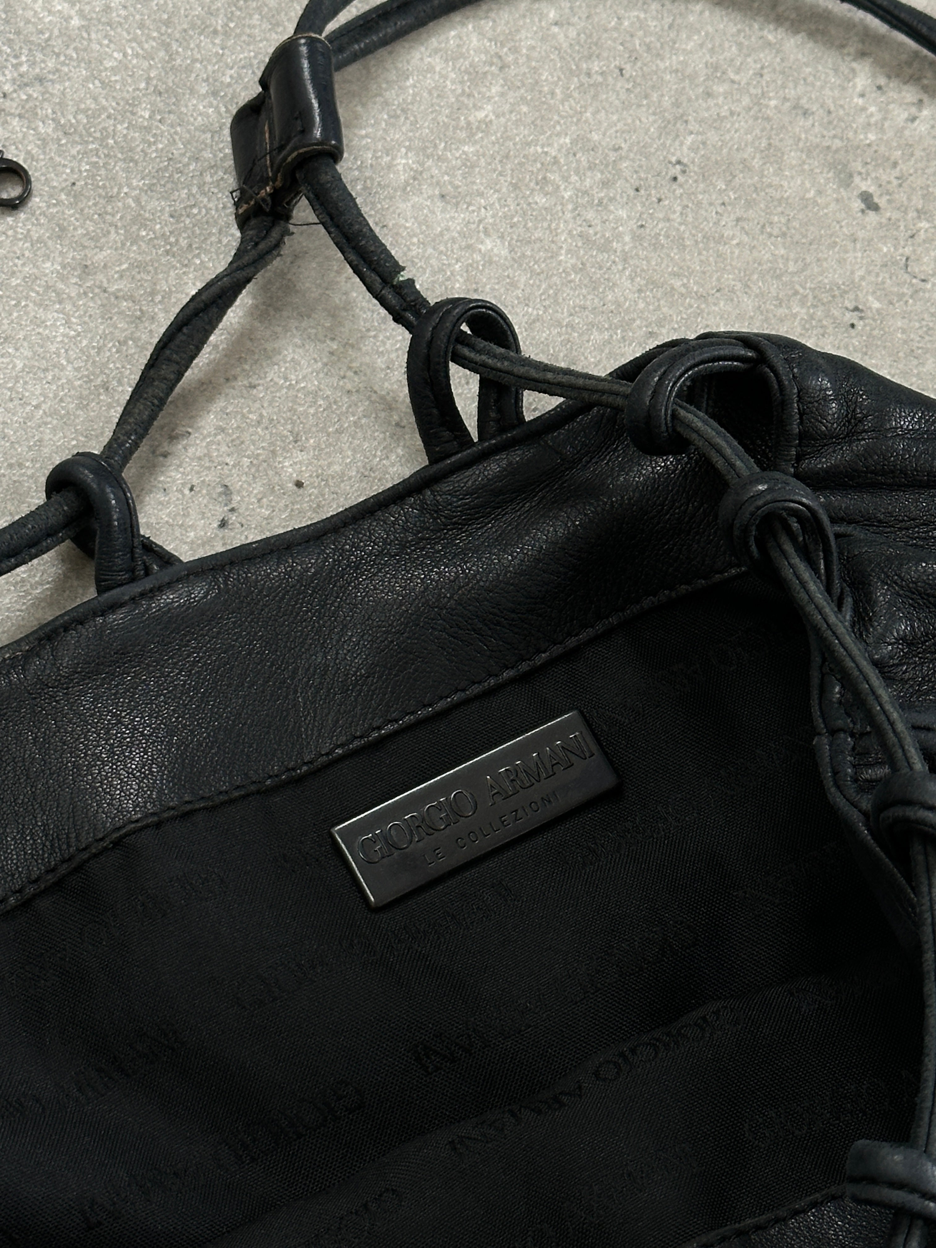 Giorgio Armani Le Collezioni leather rucksack bag with adjustable straps and sleek design, showcasing high-quality craftsmanship.