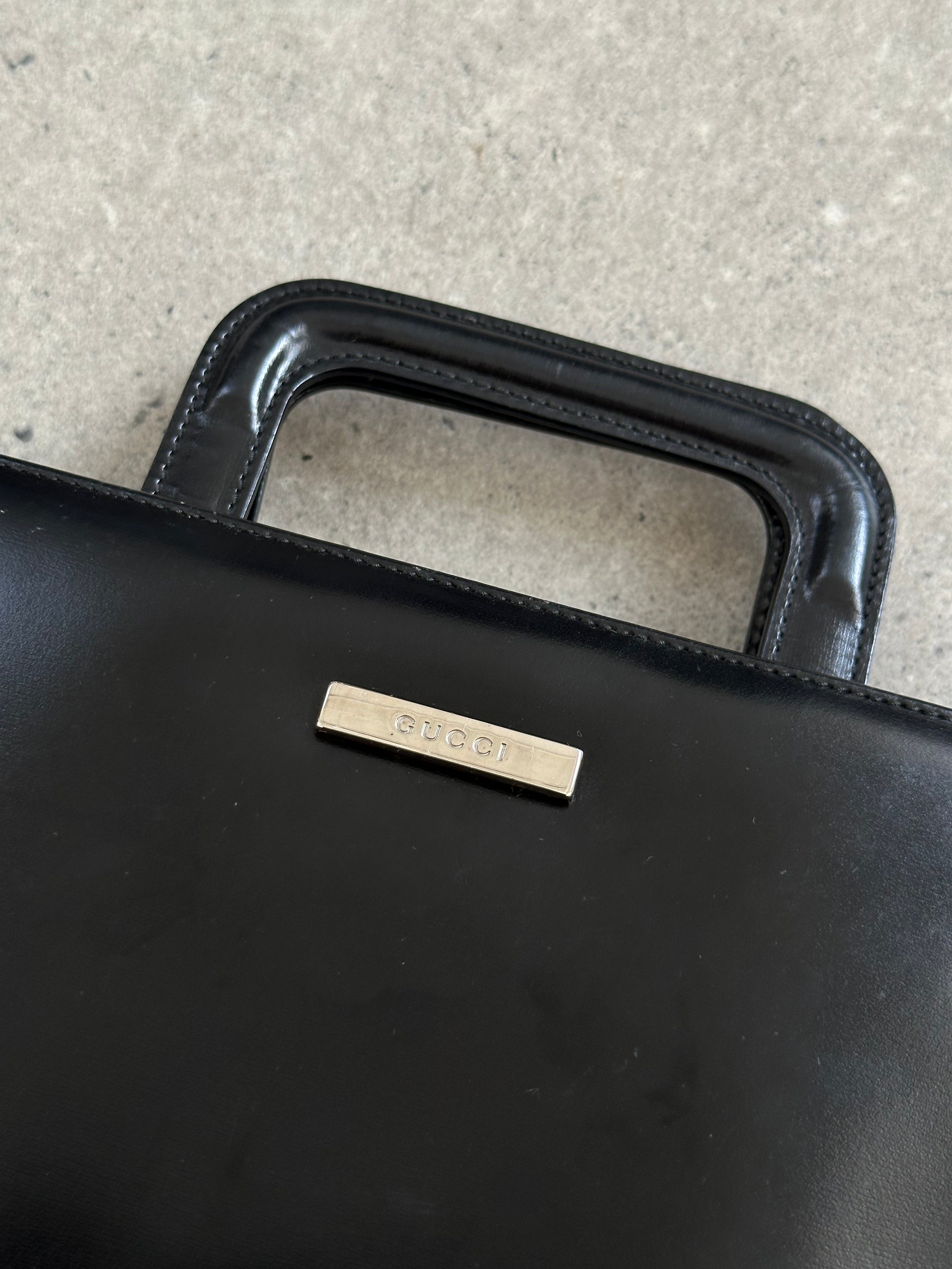 Gucci 1990s Tom Ford 2-in-1 leather and vinyl handbag with top handle and vintage design.