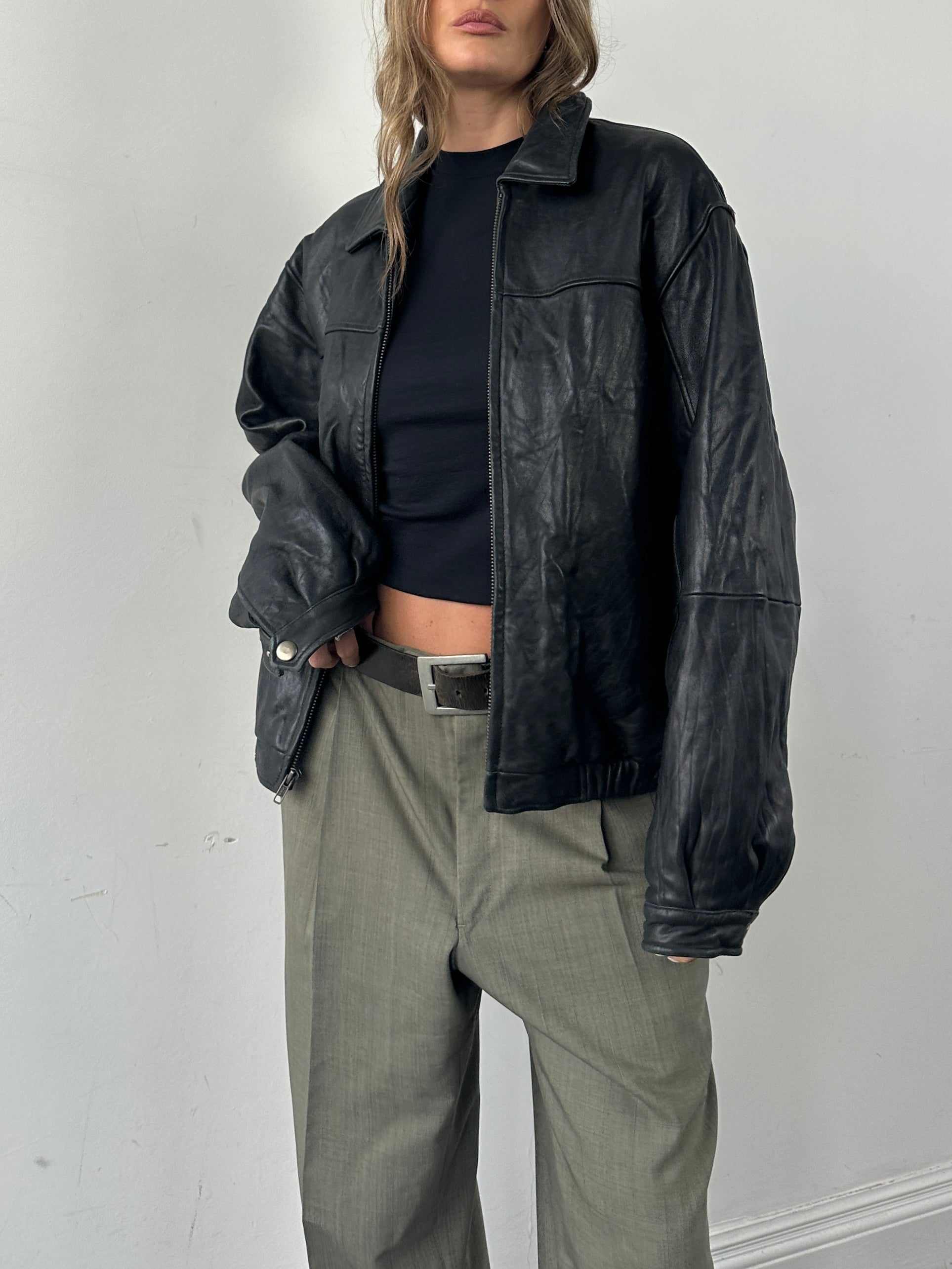Vintage minimal soft leather bomber jacket for men, shown in classic style with a smooth leather finish and ribbed cuffs.
