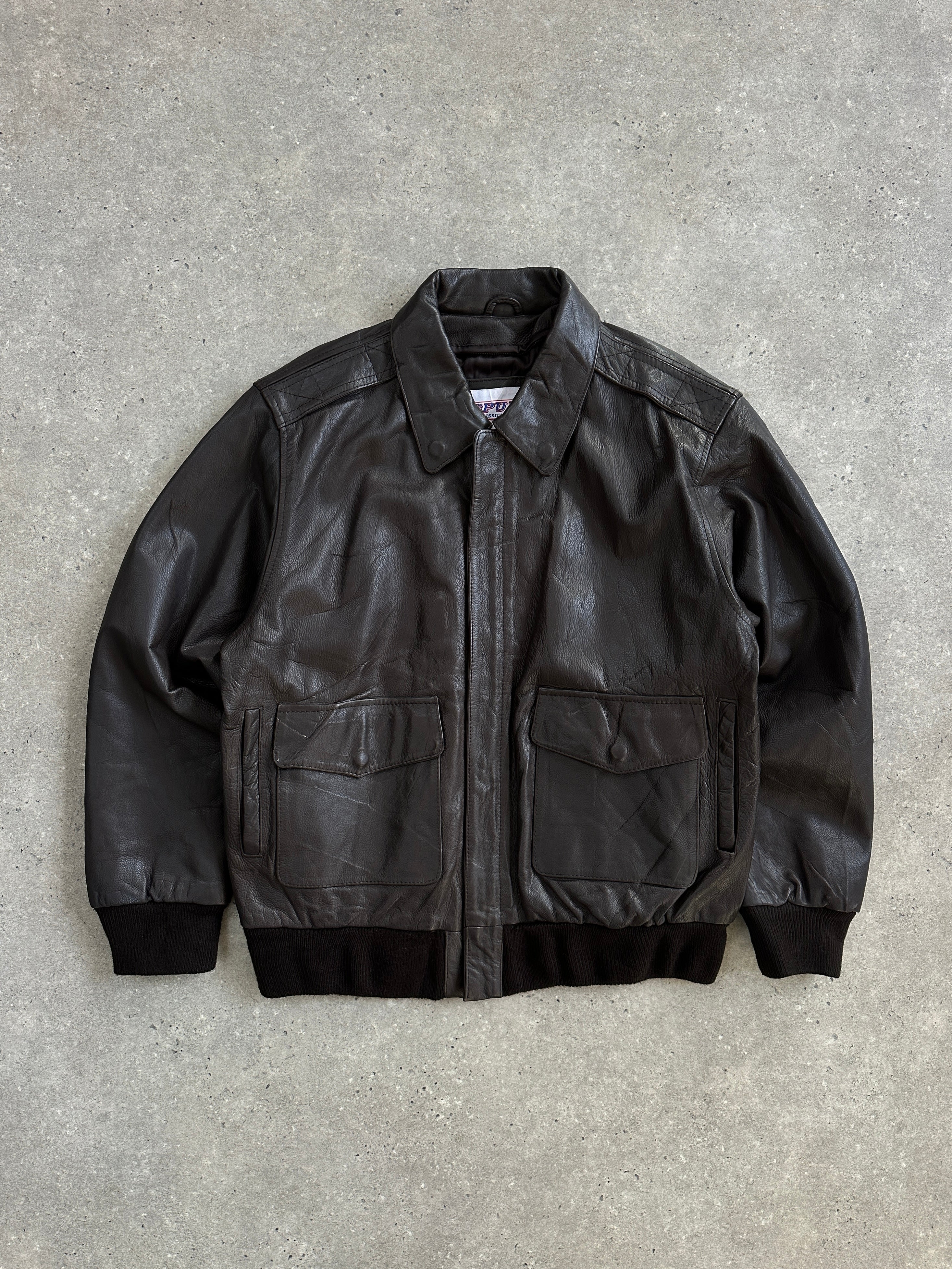 Vintage 1990s leather bomber jacket with concealed placket in size XL, featuring classic design and aged leather texture.