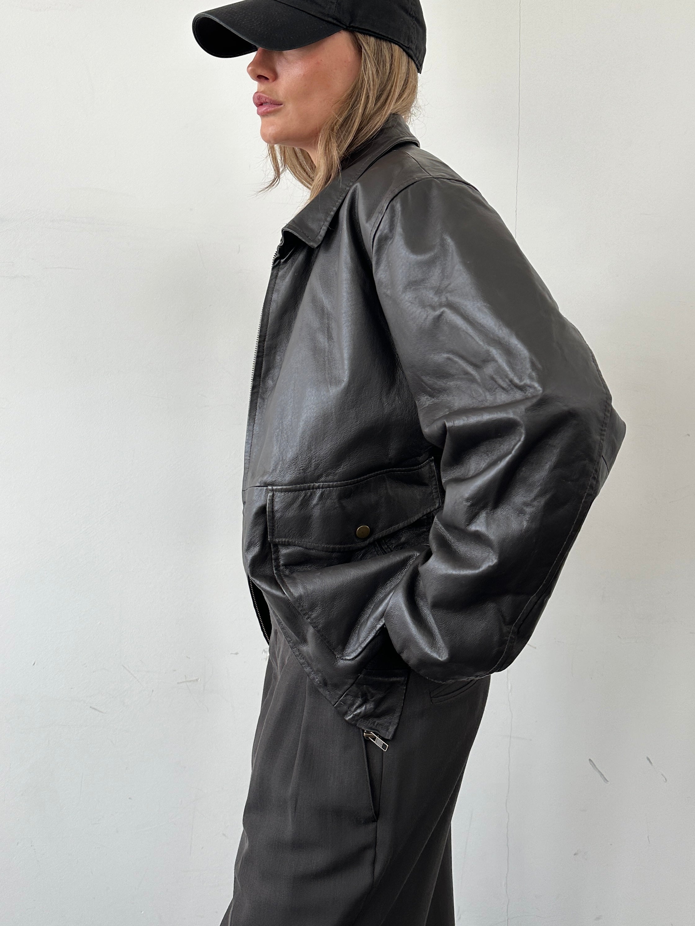 Vintage smooth leather bomber jacket in size large, featuring classic design and detailed stitching, stylish and durable for everyday wear.