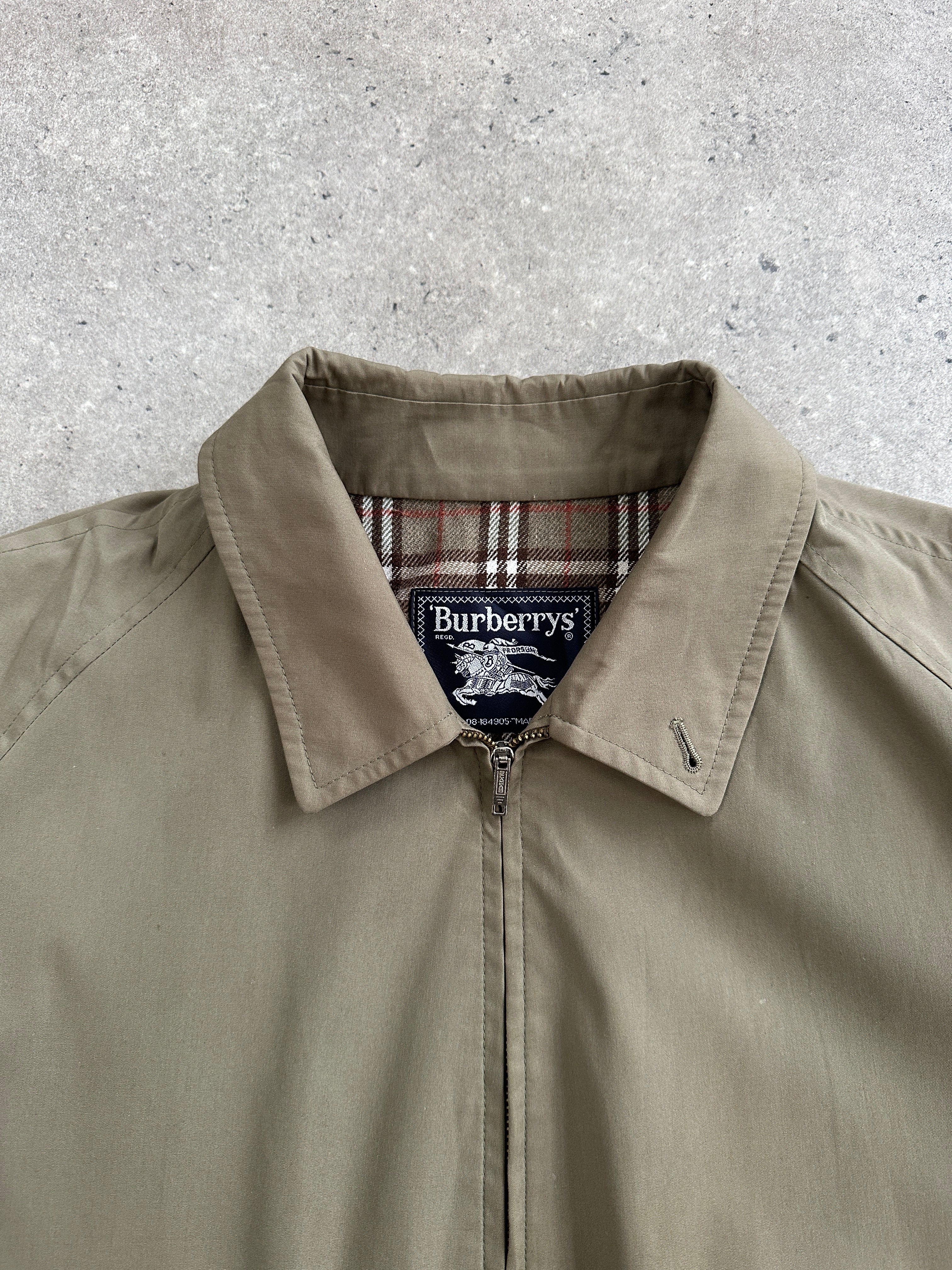 Burberry 1990s wool logo bomber jacket in XL, featuring classic design and signature branding, displayed on a hanger.