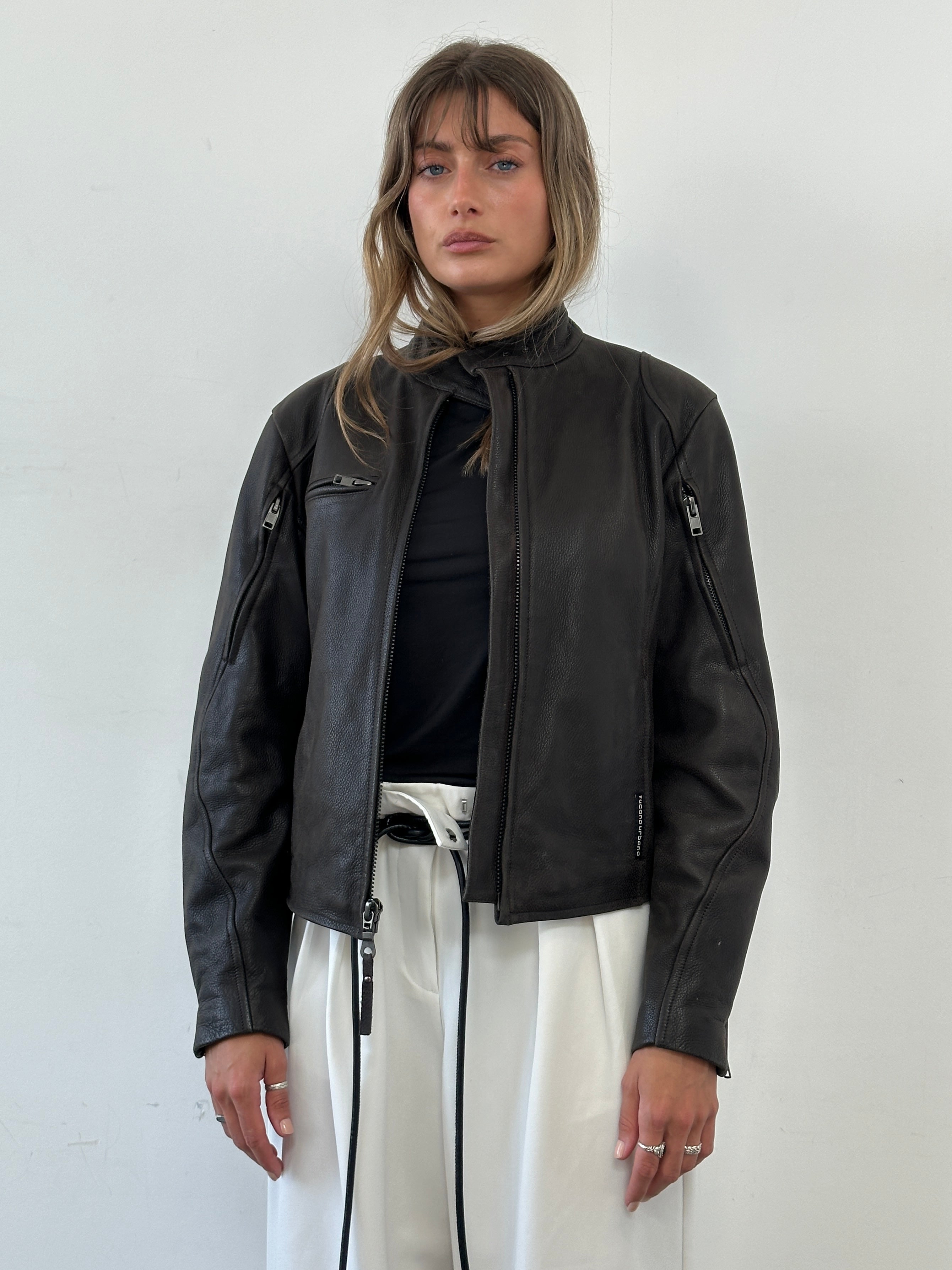 Vintage leather moto jacket in black, featuring classic design with silver zipper details, styled for a casual, edgy look.