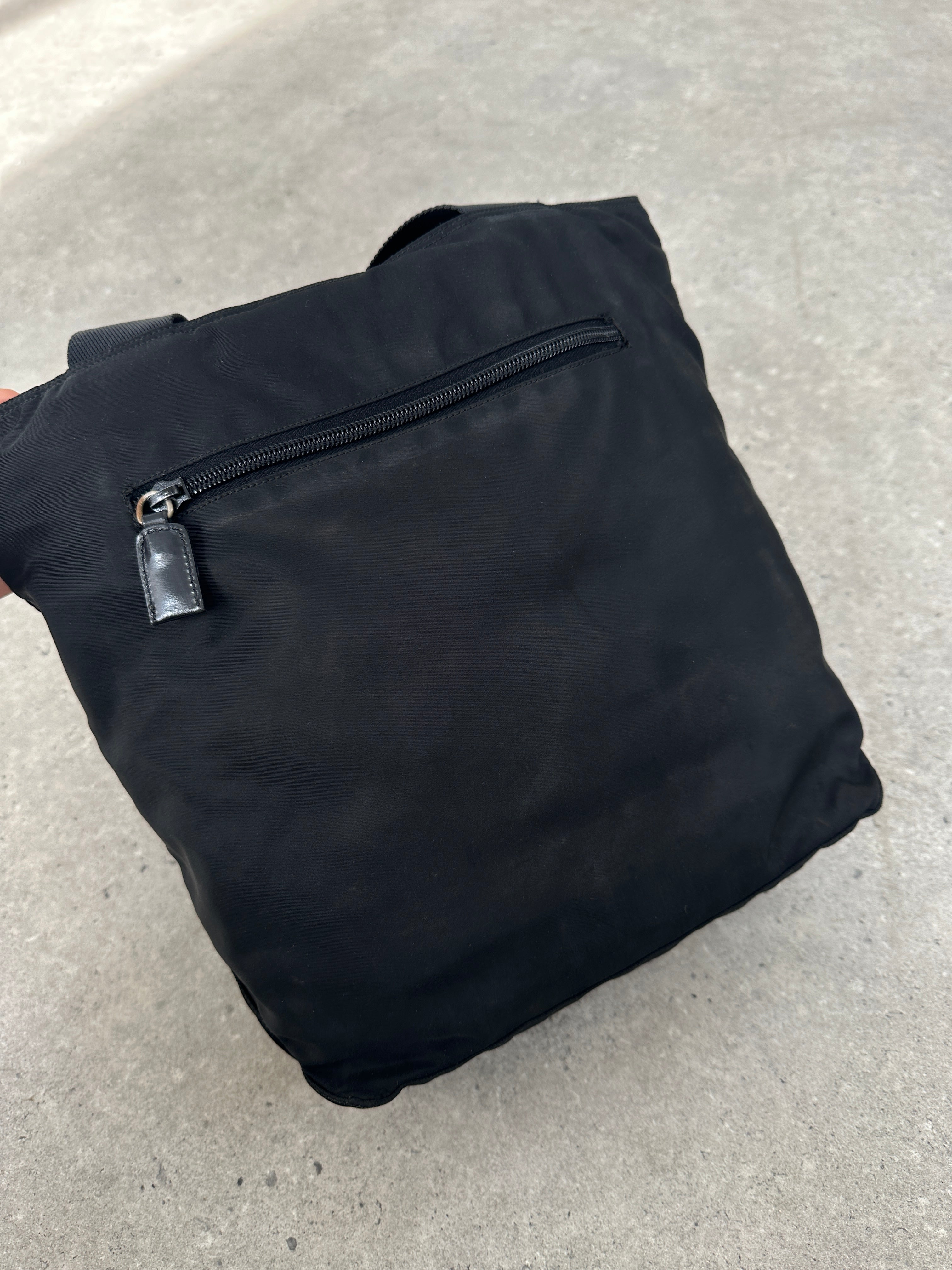 Prada 1997 nylon shoulder bag with adjustable strap and sleek design, featuring the iconic Prada logo on the front.