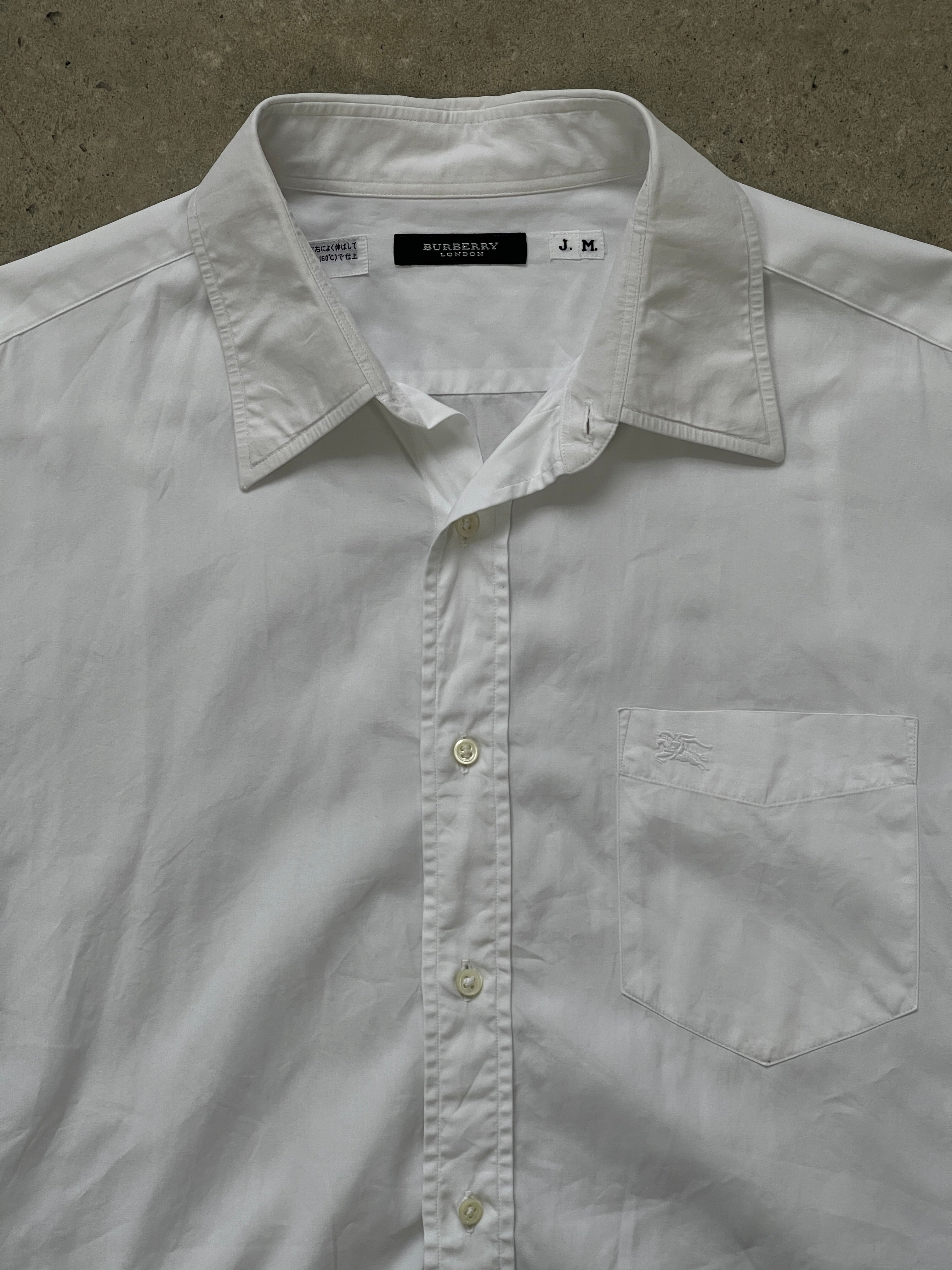 Burberry London 2000s cotton logo shirt in size M/L, featuring classic check pattern and iconic branding on the front.
