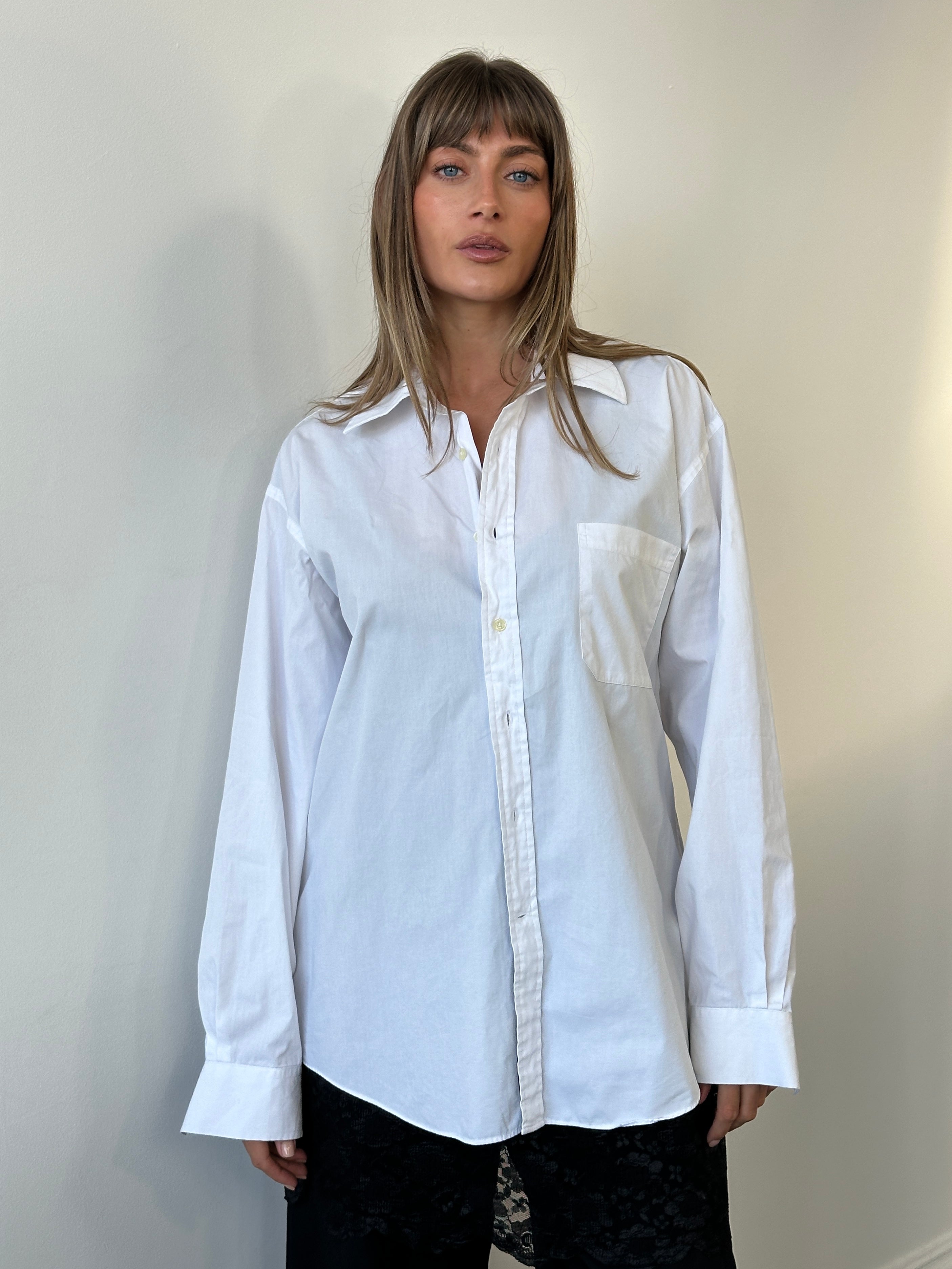 Christian Dior 1990s cotton shirt, XL size, featuring classic design and elegant fabric, displayed on a hanger.