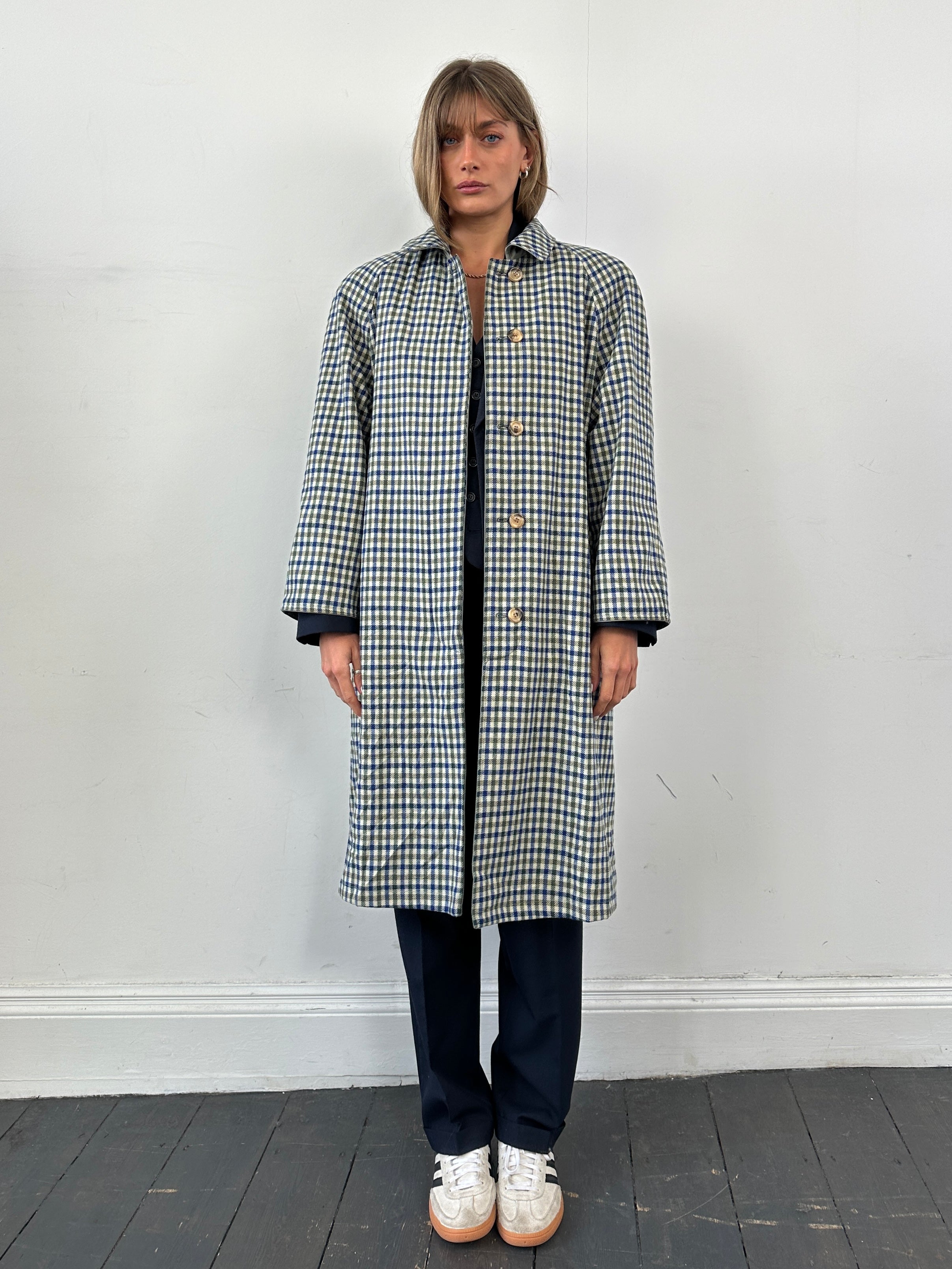 Vintage reversible check trench coat with belt, featuring classic design and versatile style, shown in the image.