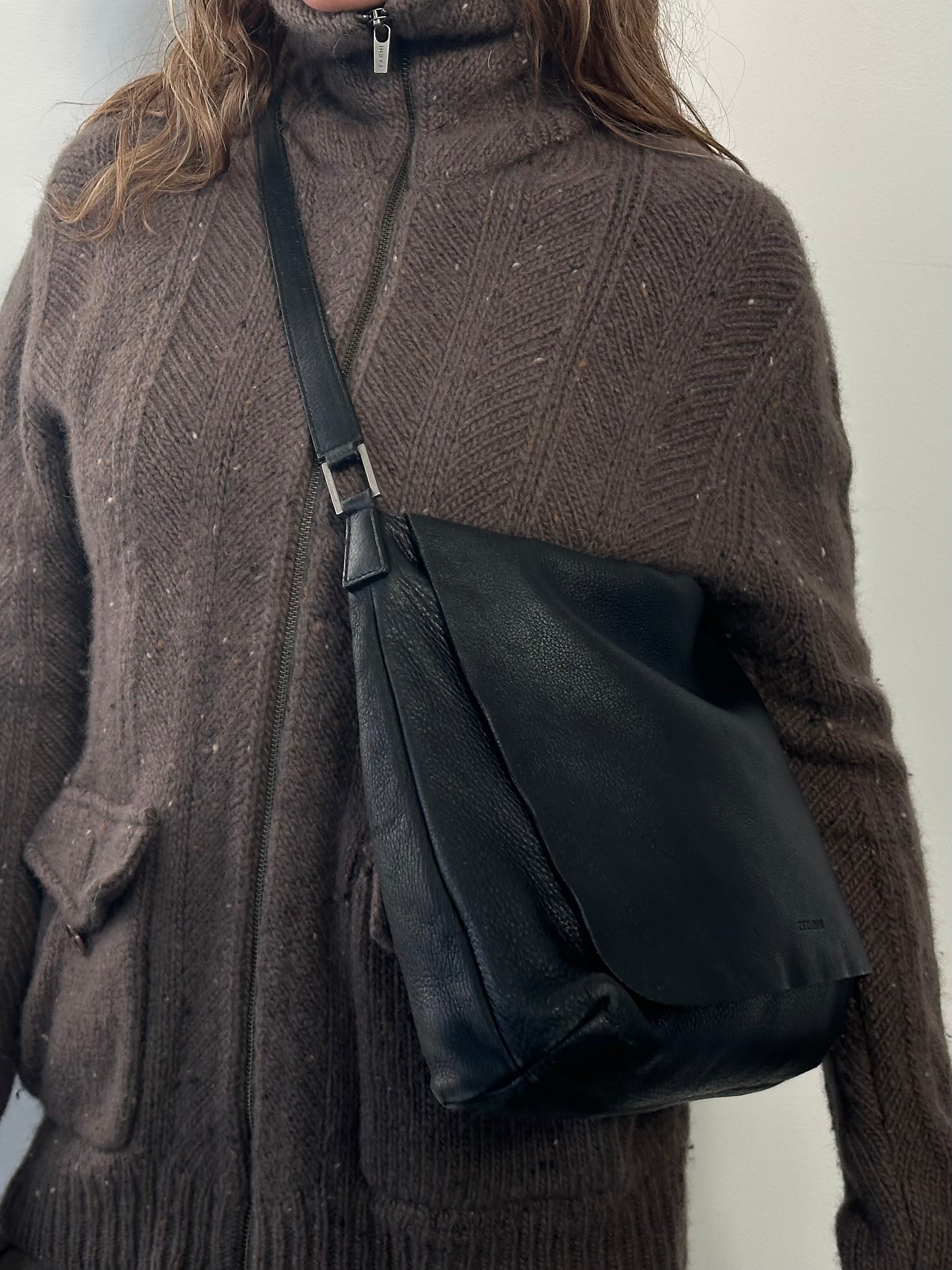 Giorgio Armani 2000s leather crossbody bag with sleek design and adjustable strap, featuring the Armani logo.