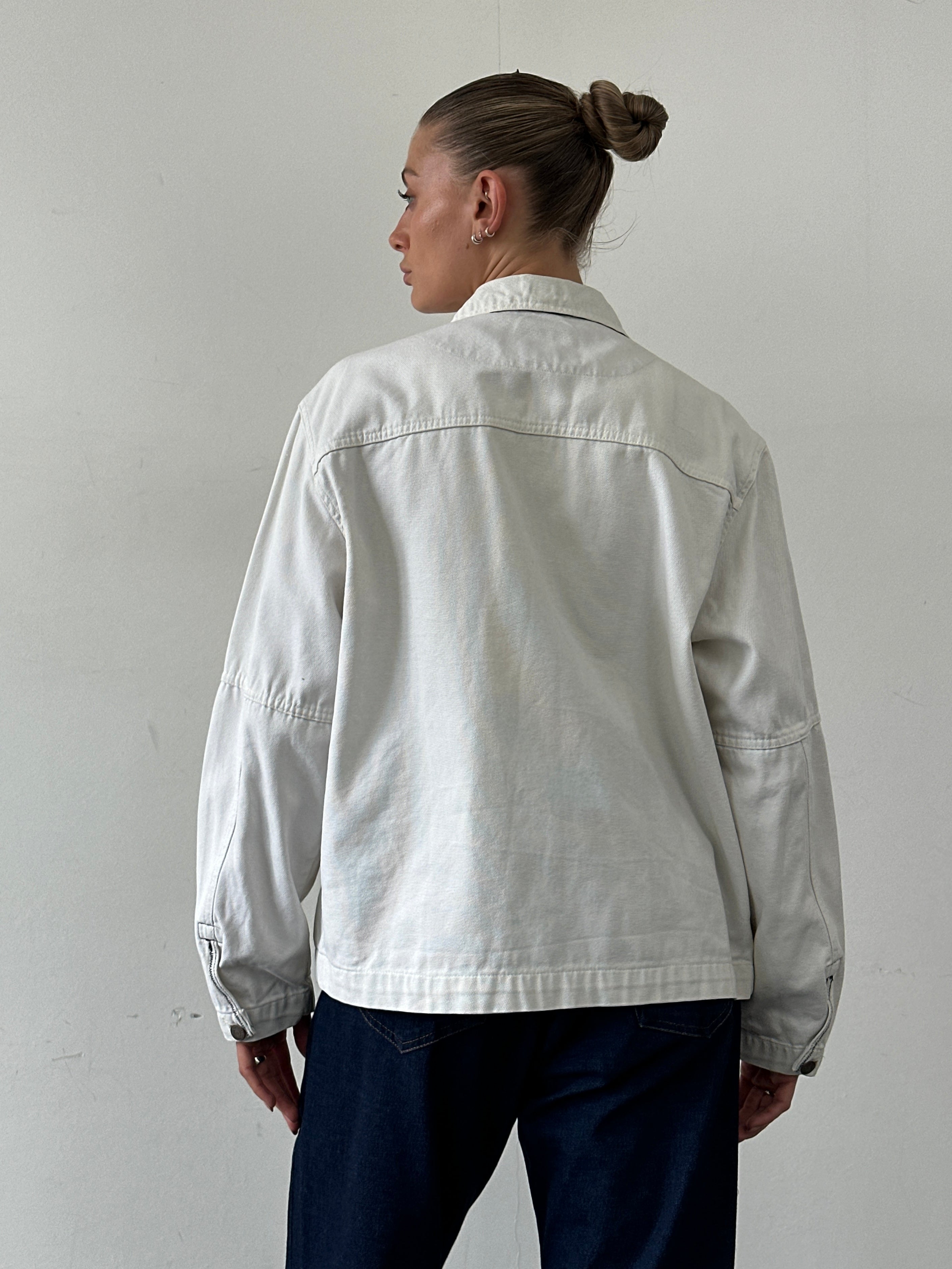 Levi’s cotton zip-up bomber jacket in size L, navy blue with ribbed cuffs and collar, front zipper, and side pockets.