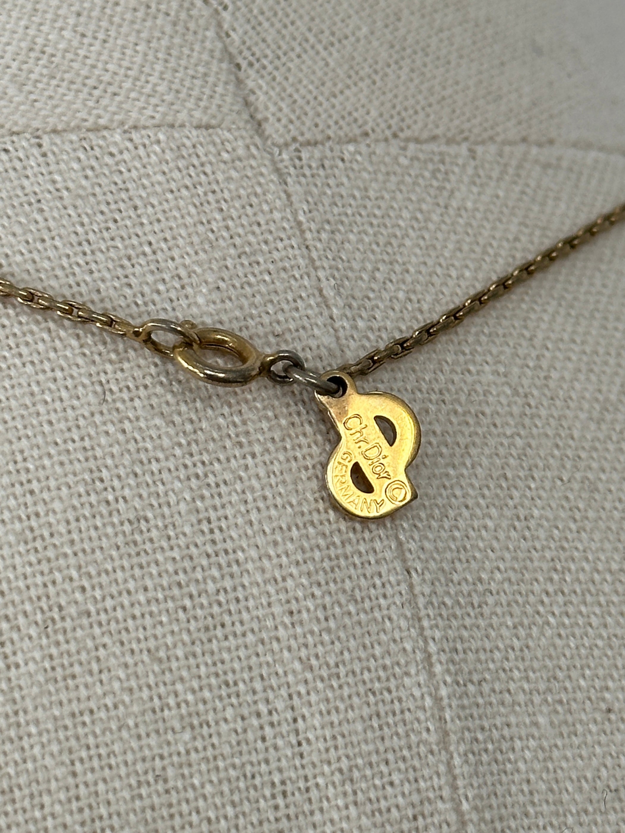 Christian Dior 1990s gold plated CD logo pendant necklace, 16-inch chain, close-up of the iconic Christian Dior jewelry design.