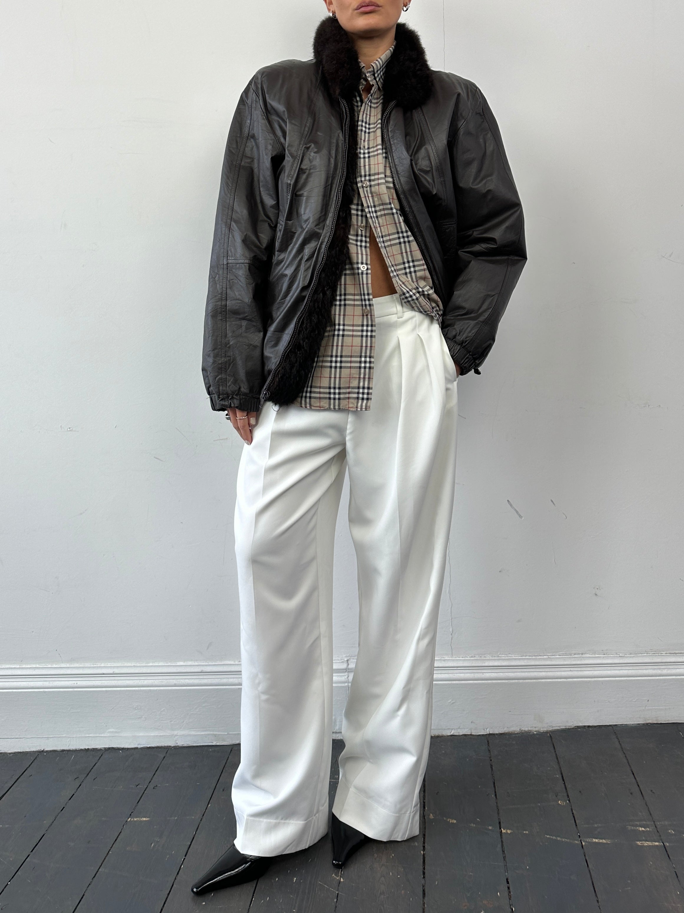 Vintage faux fur-lined minimal leather bomber jacket in size small, featuring a sleek design and classic style.