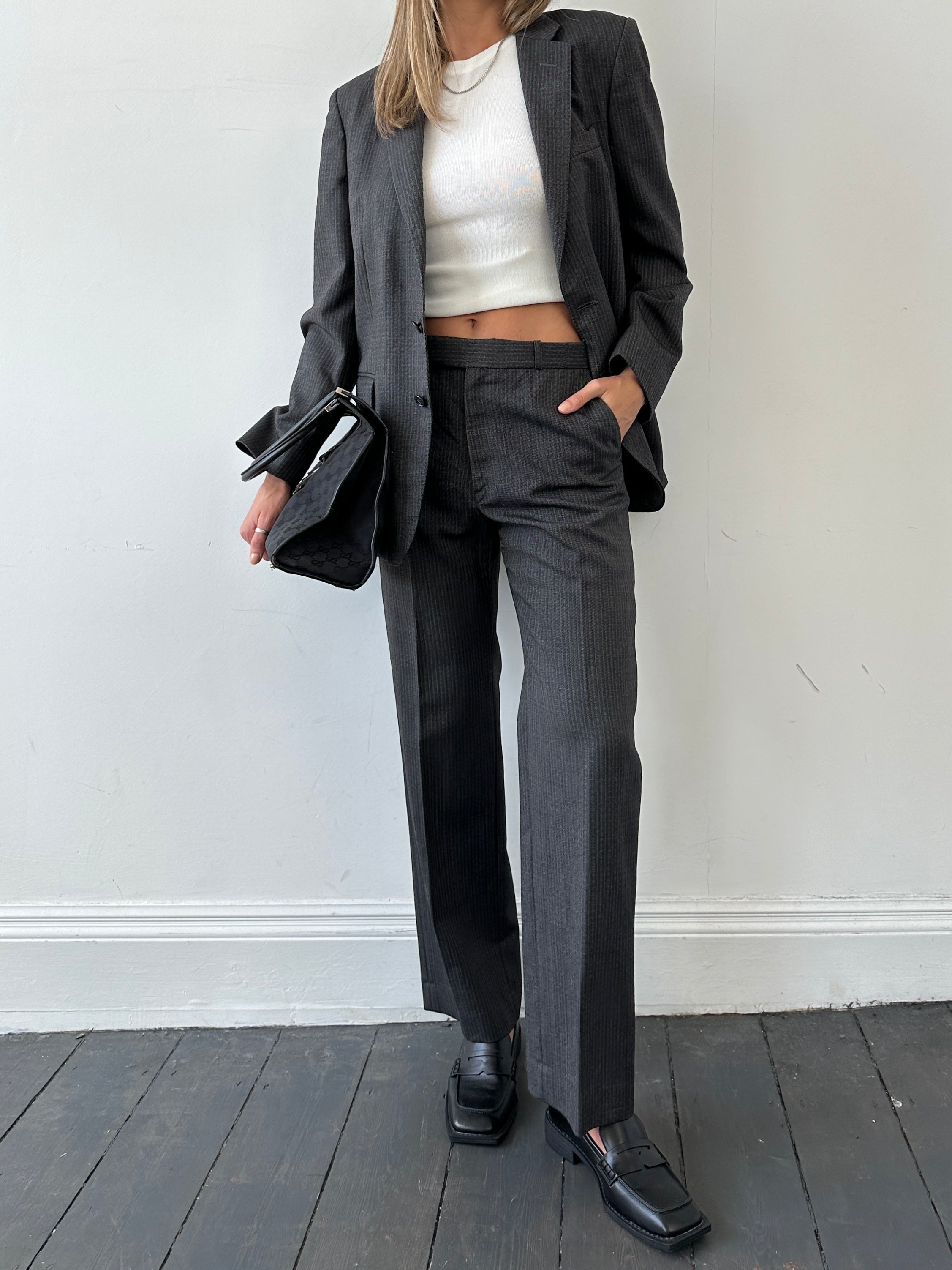 Christian Dior pinstripe single-breasted pure wool jumpsuit in size 40R/W32, tailored with a sleek fit and classic design.
