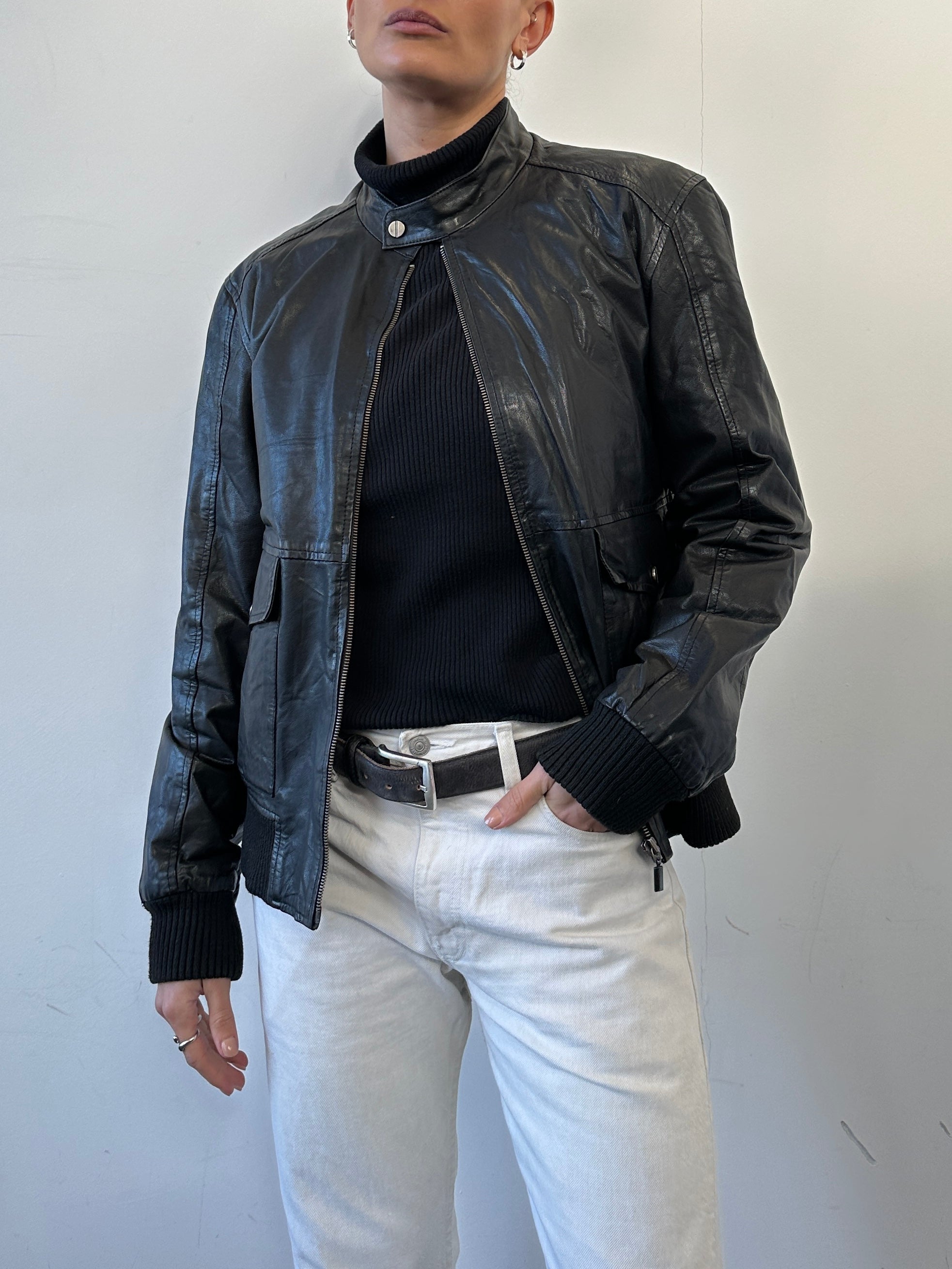 Conbipel Moto leather bomber jacket in black, featuring classic collar, zip front, and ribbed cuffs, worn by a model.