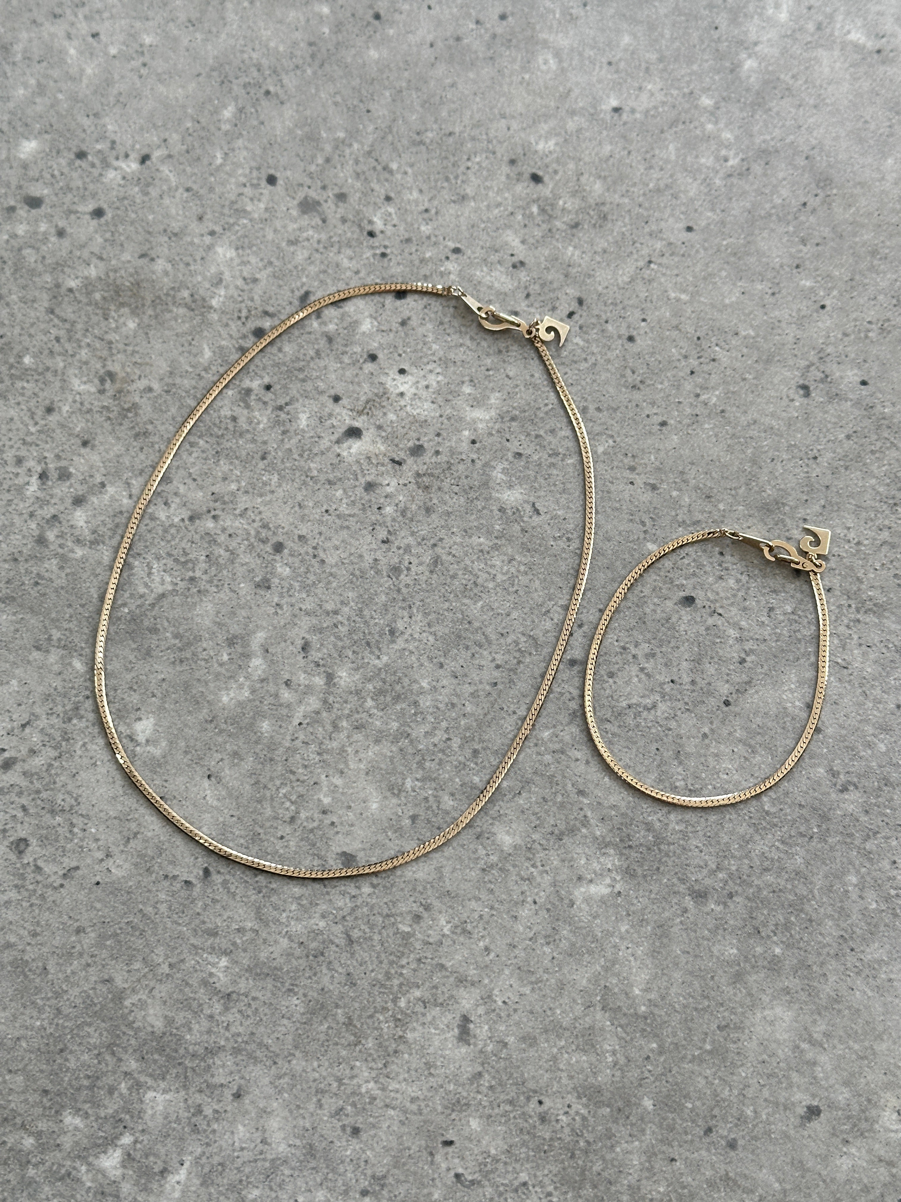 Pierre Cardin gold plated necklace and bracelet chain set, featuring sleek, polished jewelry with a shiny gold finish.