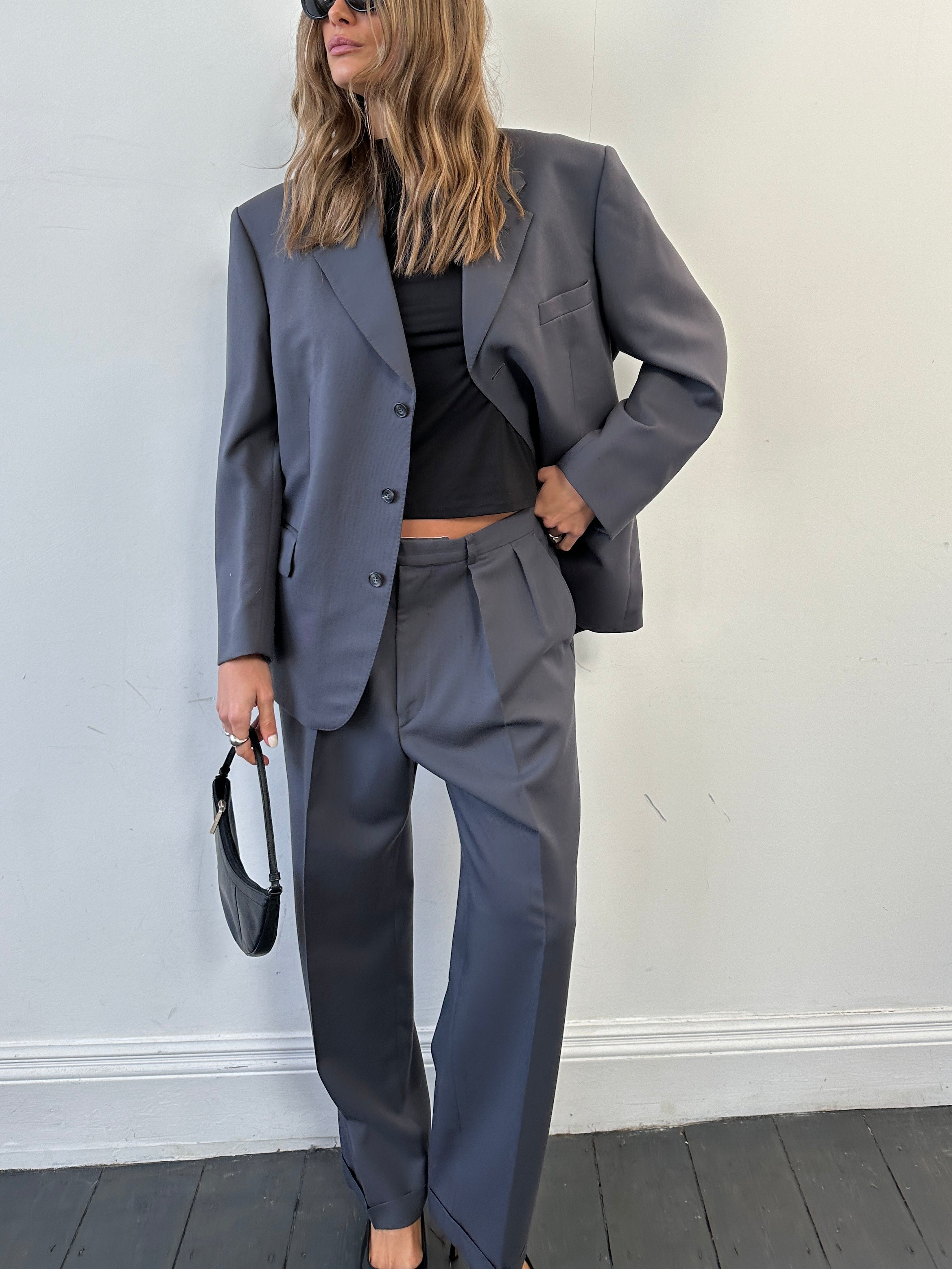 Christian Dior wool single-breasted suit jumpsuit in size 42S/W34, featuring tailored lapel and classic fit, on a hanger.
