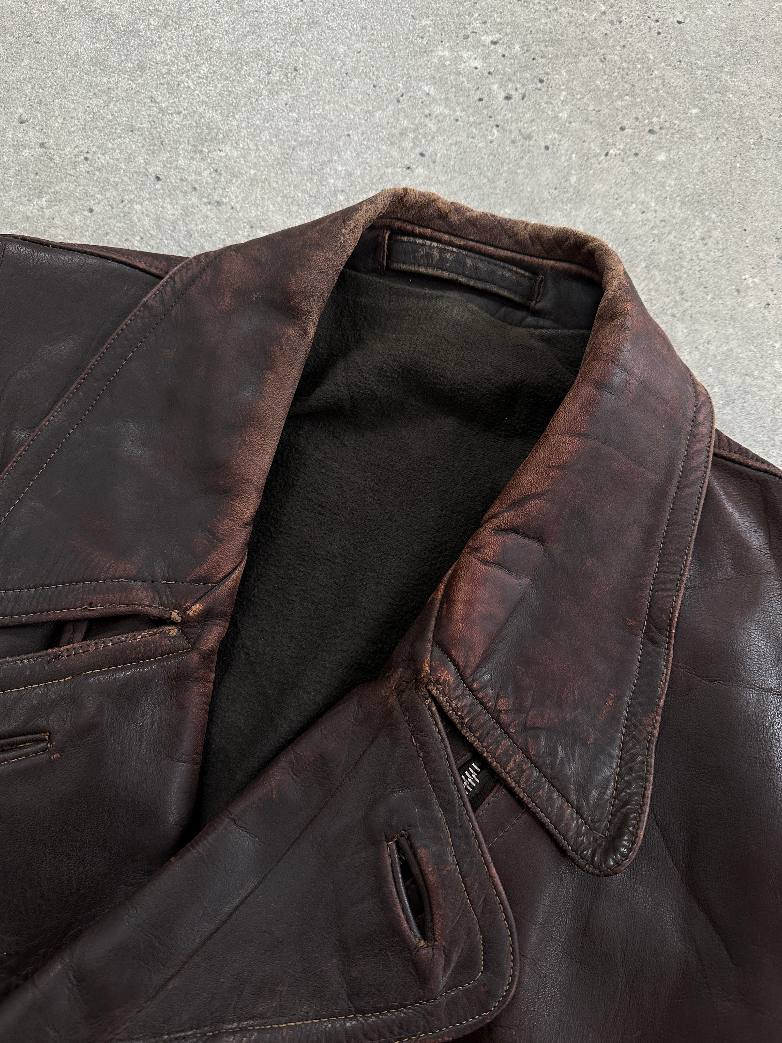Vintage distressed leather biker jacket, 1980s style, in size L/XL, featuring rugged design and classic motorcycle jacket details.