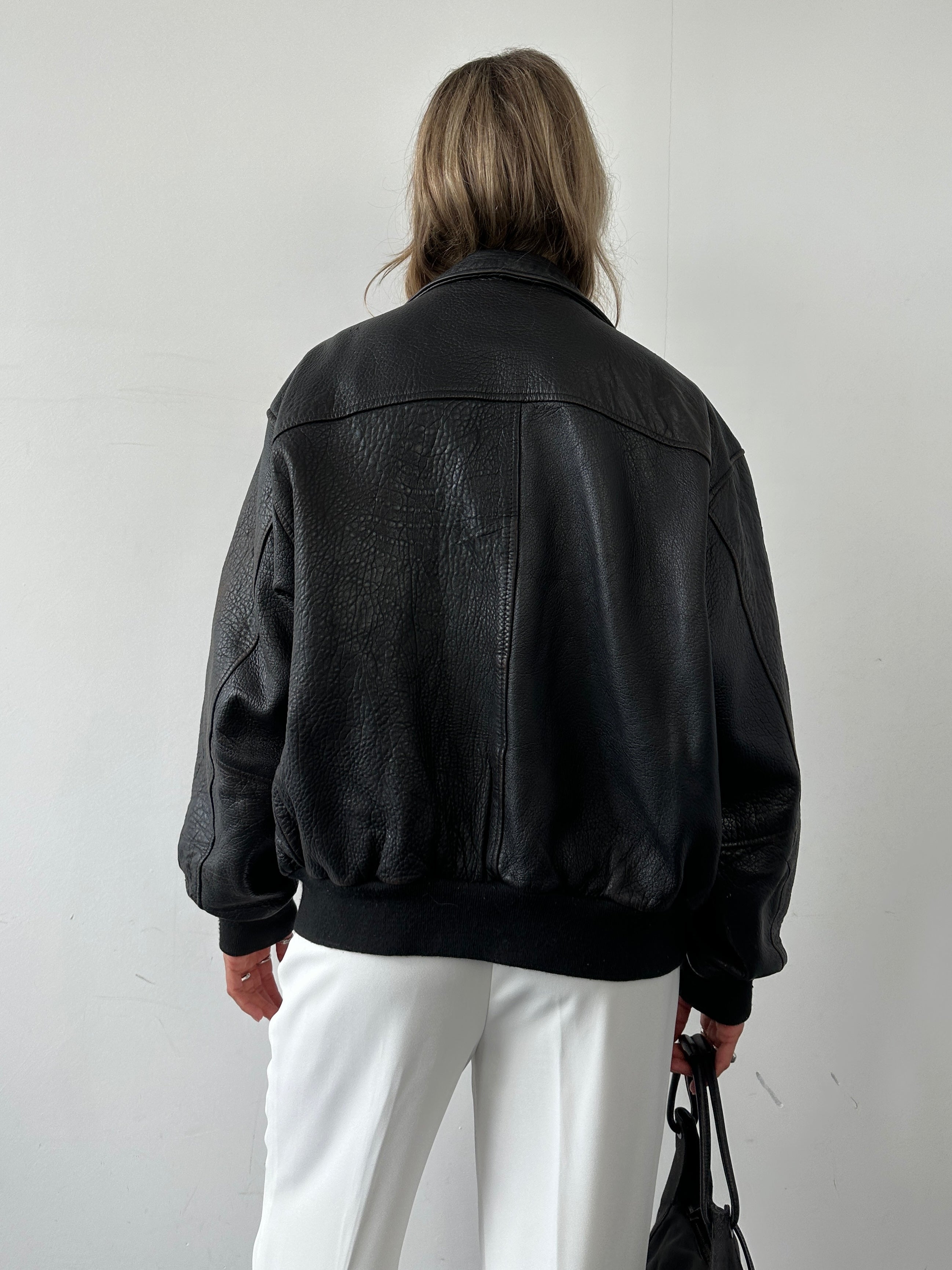Vintage British leather bomber jacket in size M, featuring classic design, rugged leather texture, and vintage-inspired style.