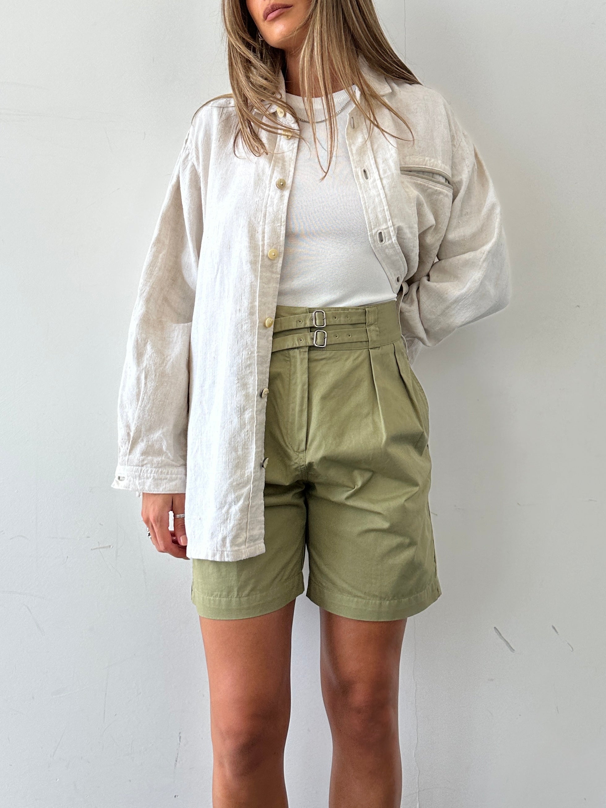 Lacoste high waisted pure cotton shorts in white, showing front view with belt loops and classic crocodile logo detail.