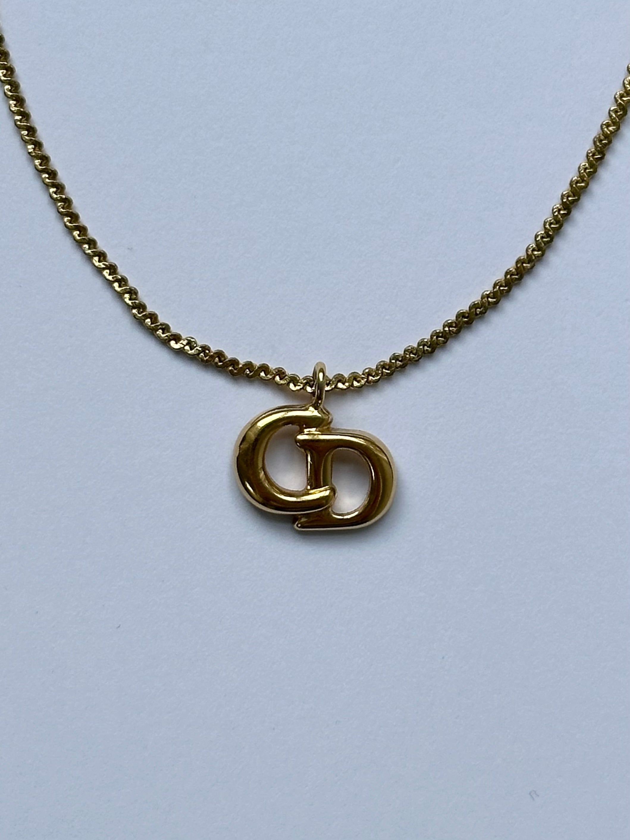 Christian Dior 16-inch gold plated logo pendant necklace showing the elegant chain and signature Dior logo pendant.