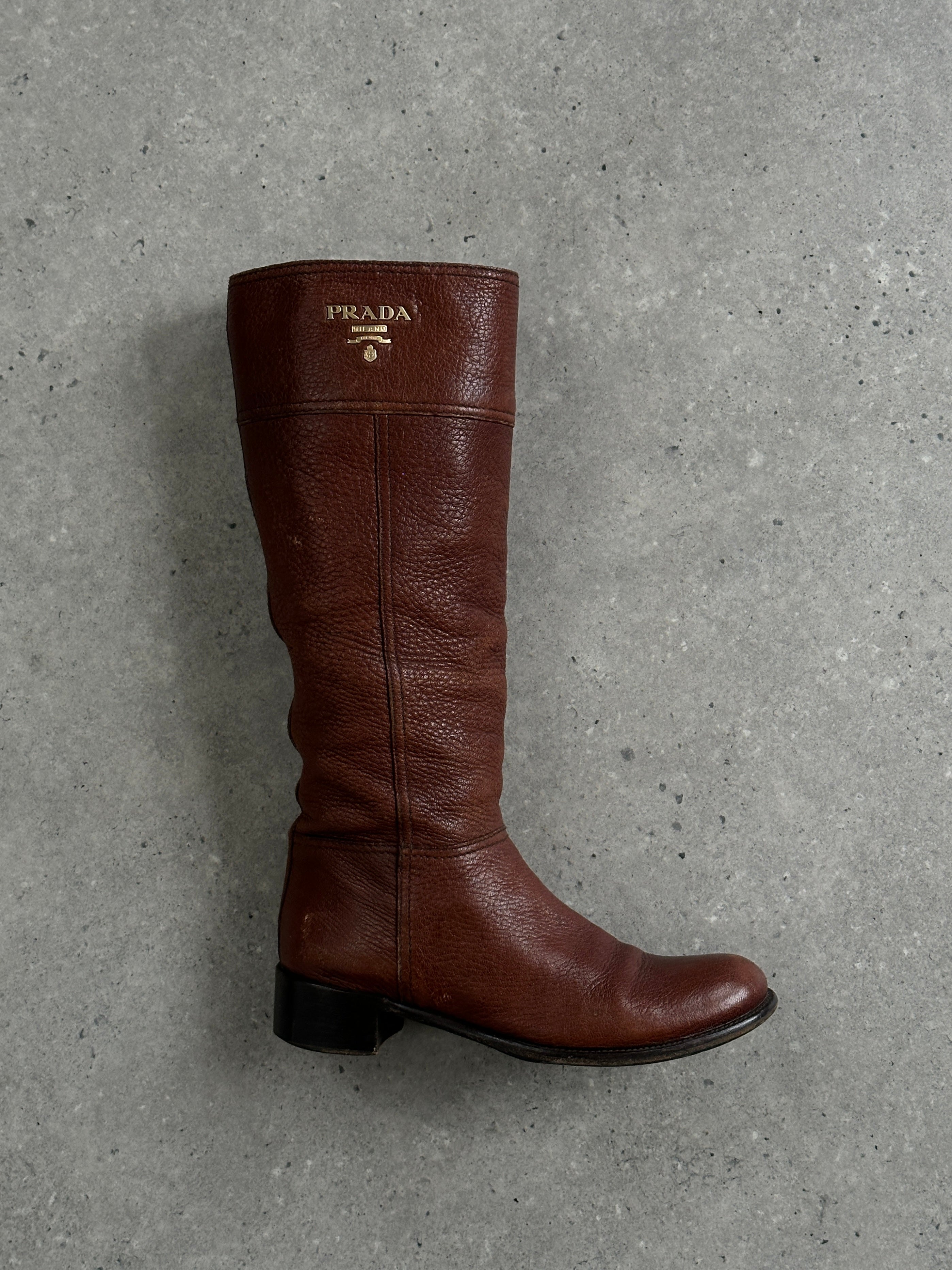 Prada leather knee boots in black with logo detail, UK size 4, EUR 37, featuring sleek design and pointed toe.