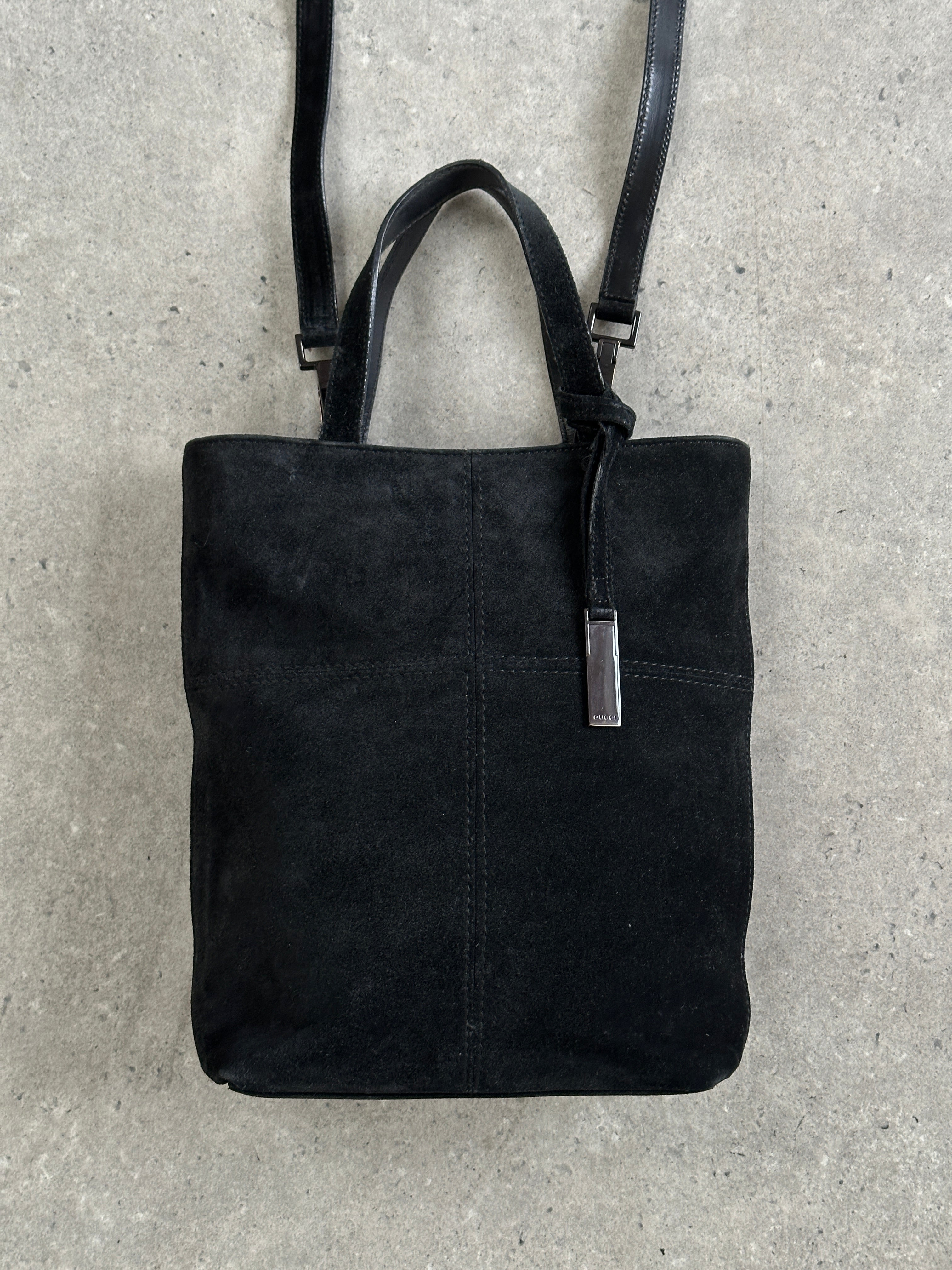 Gucci 2000s suede top handle crossbody bag with sleek design and adjustable strap, featuring the iconic Gucci logo.