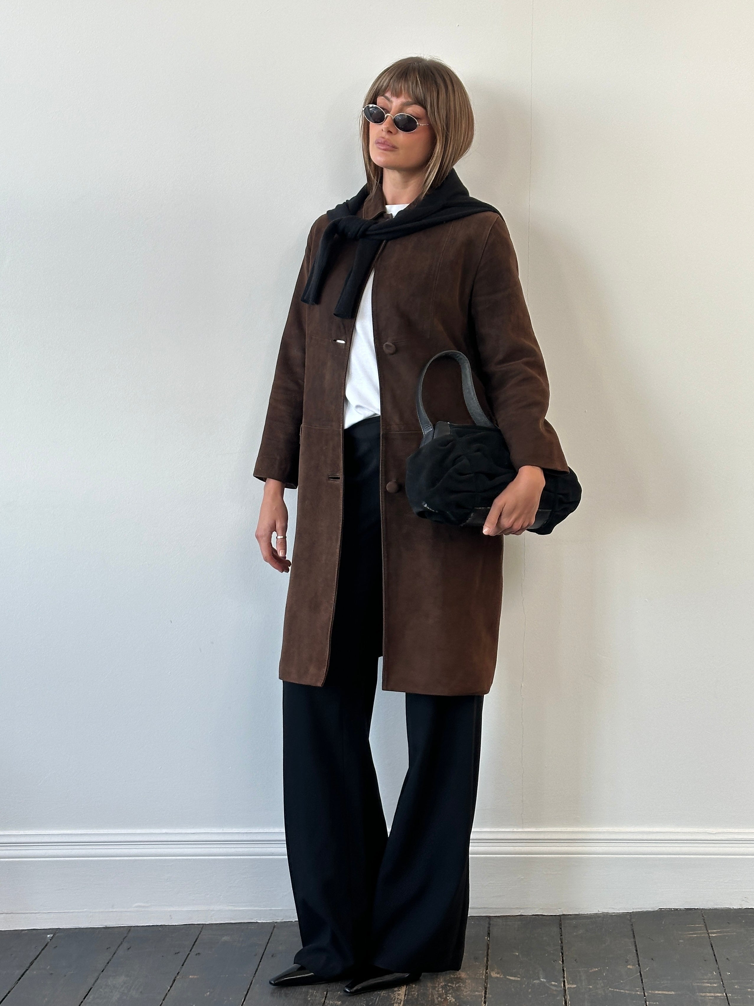 Pierre Balmain alligator suede trench coat, 1980s style, in beige with wide lapels and belted waist, displayed on a mannequin.