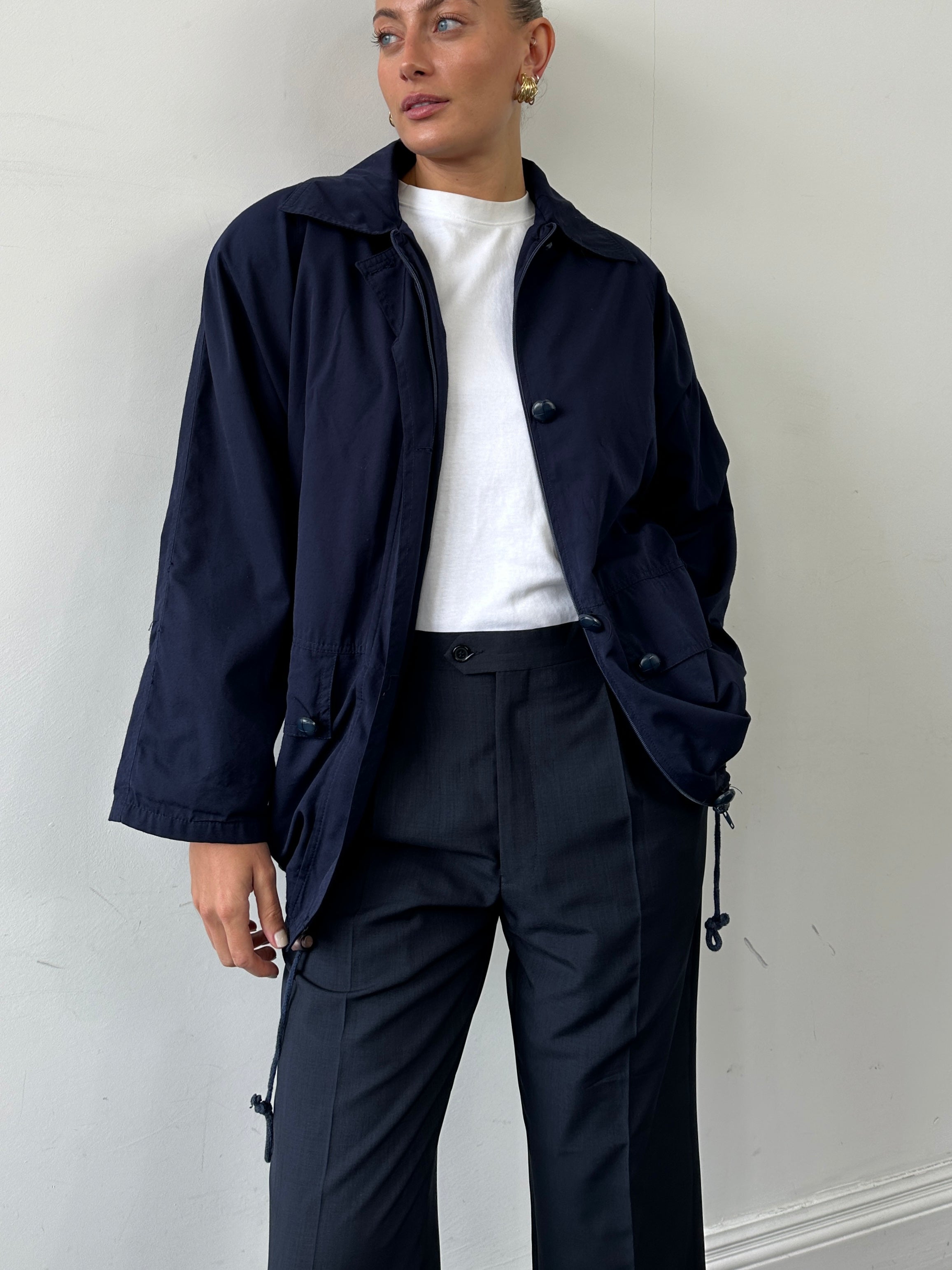 Vintage Italian bomber jacket in M/L size, featuring classic design and durable fabric, displayed on a hanger.