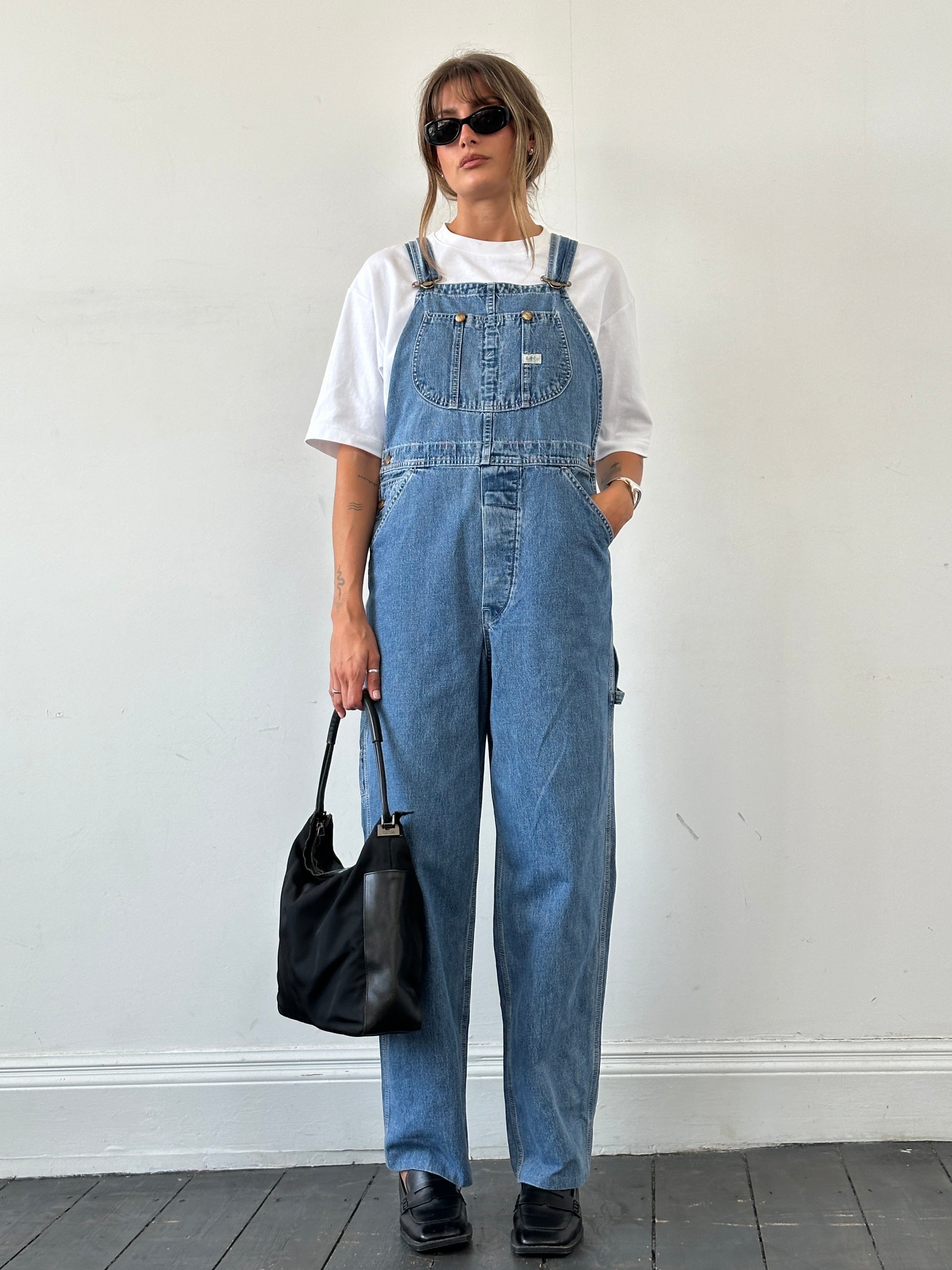 Lee Pure Cotton Denim Dungarees for men, featuring classic blue denim with adjustable straps and front pockets.