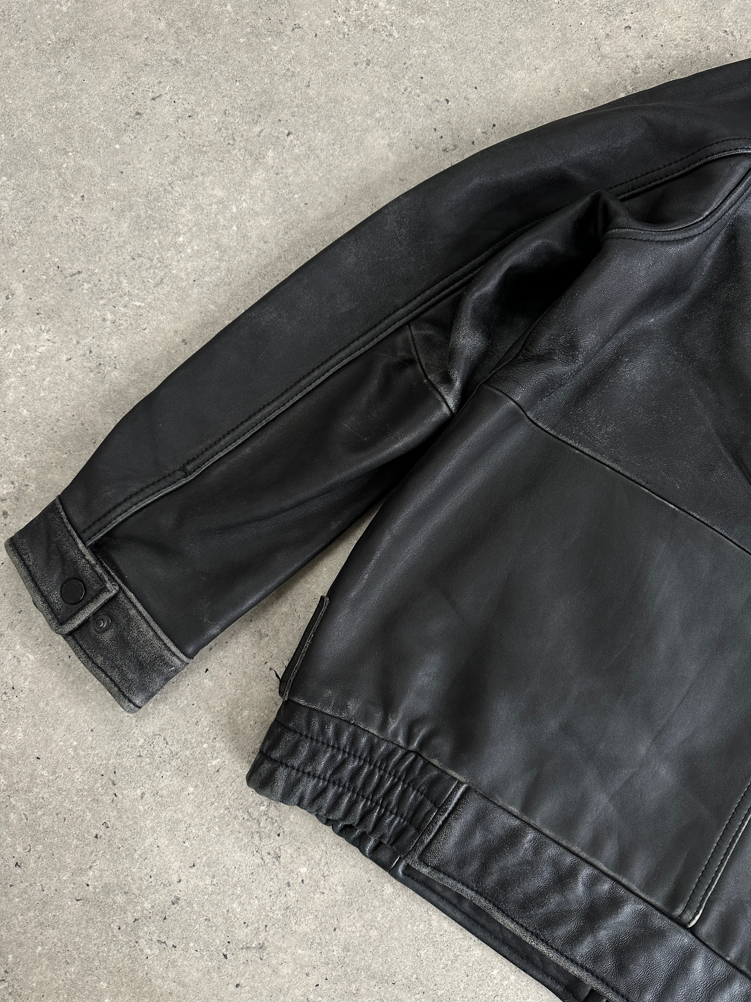 Tommy Hilfiger distressed leather bomber jacket in size M, shown with rugged style and classic fit, front view with zipper closure.