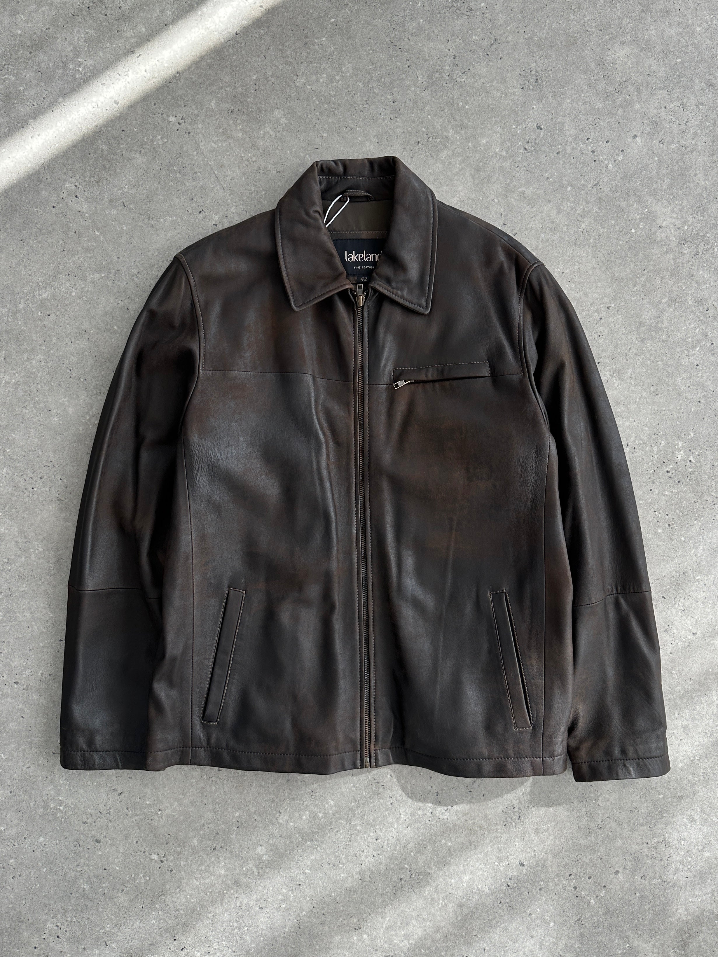 Vintage aged leather jacket in XL size, showcasing distressed brown leather with classic stitching and vintage style details.