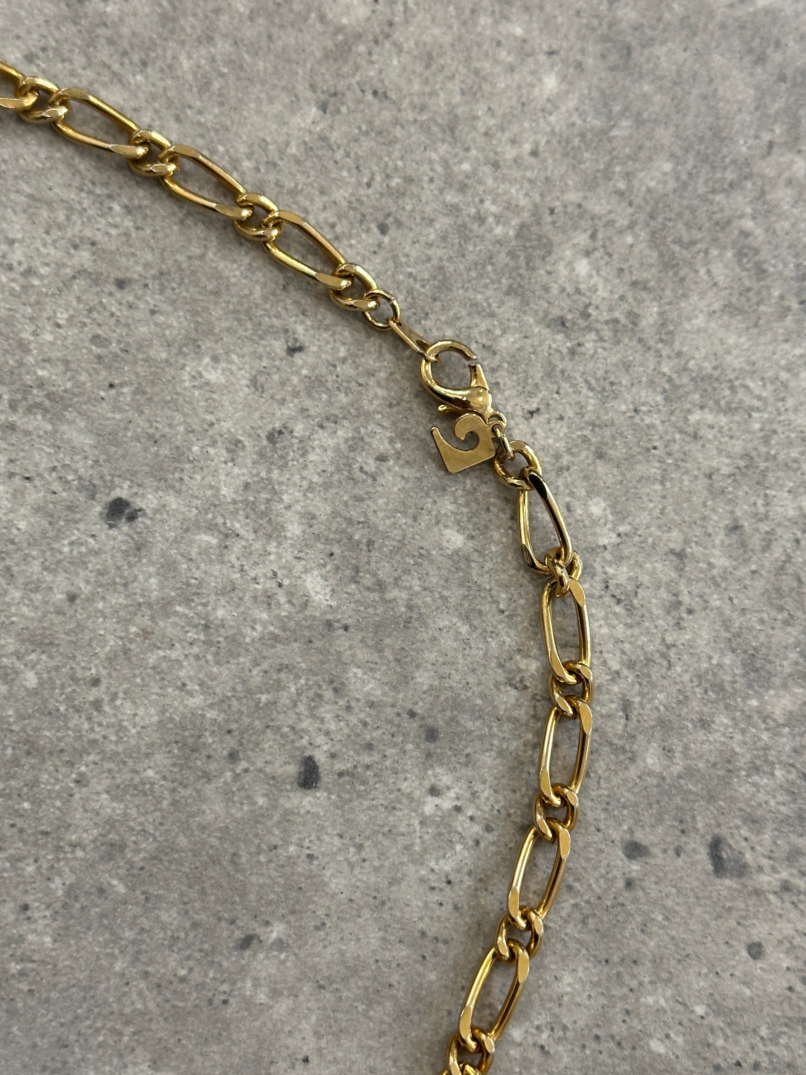 Gold plated Pierre Cardin necklace with a delicate chain and subtle pendant, showcasing elegant jewelry design.