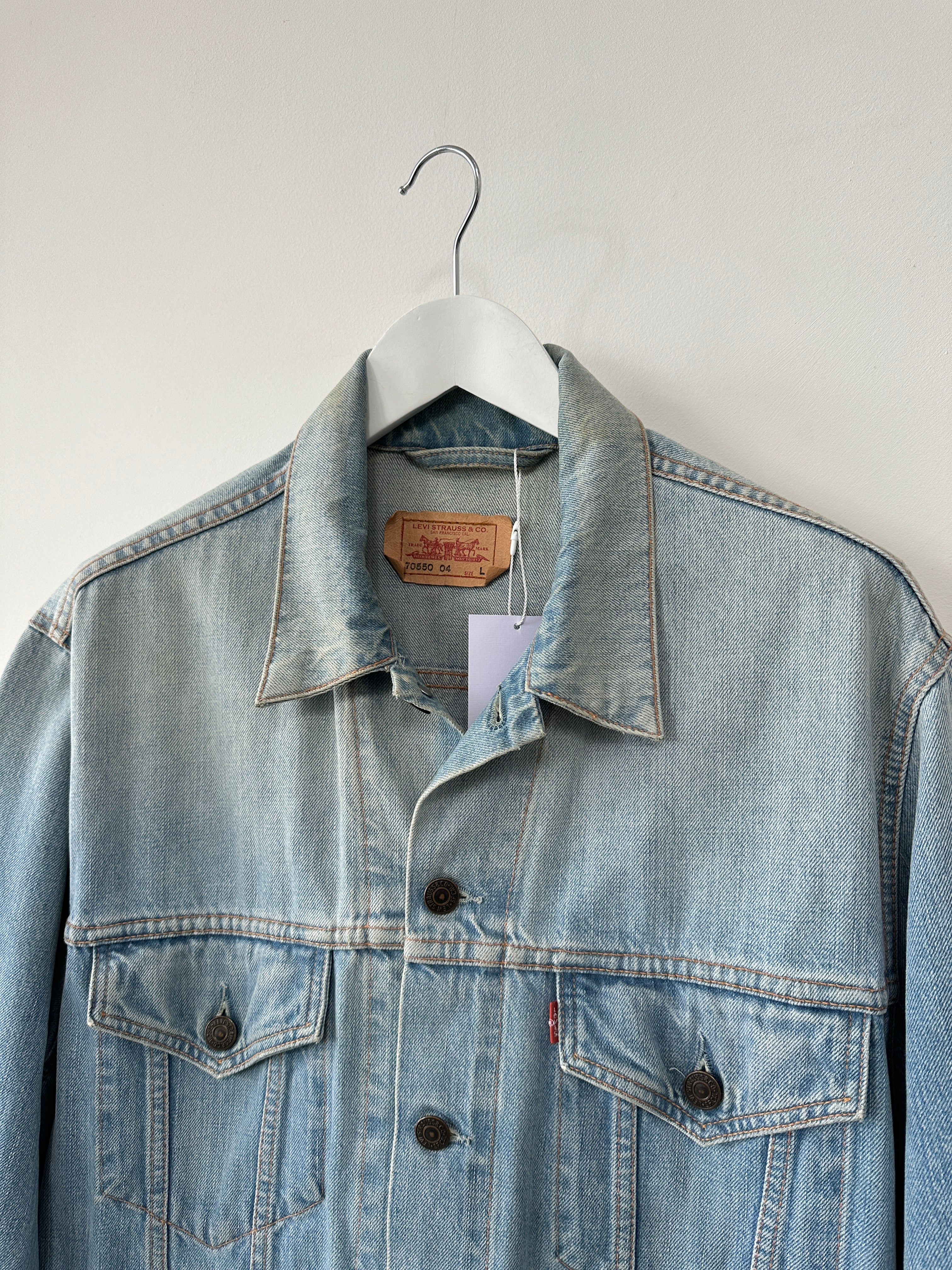 Levi’s faded denim jacket for men, showing classic blue denim with distressed details and button closure.