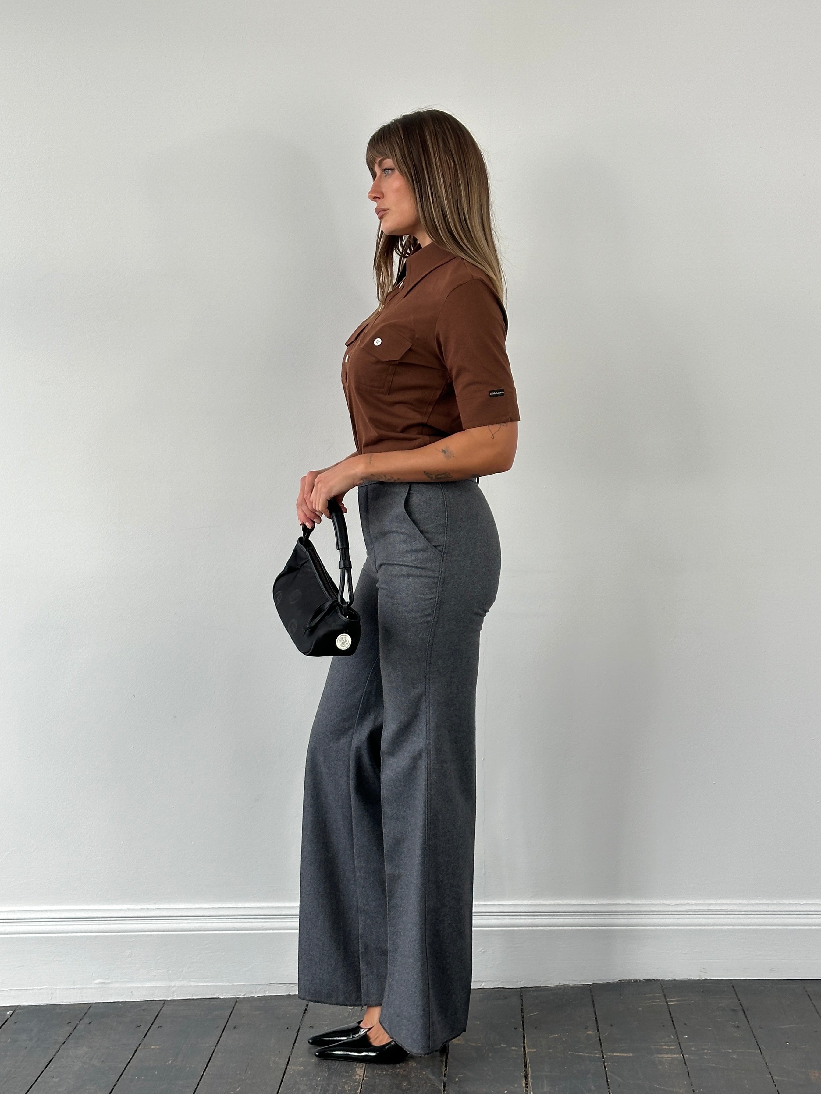 Vintage Italian 1970s wool flared tailored trousers in size W28, showcasing classic retro style and high-quality fabric.