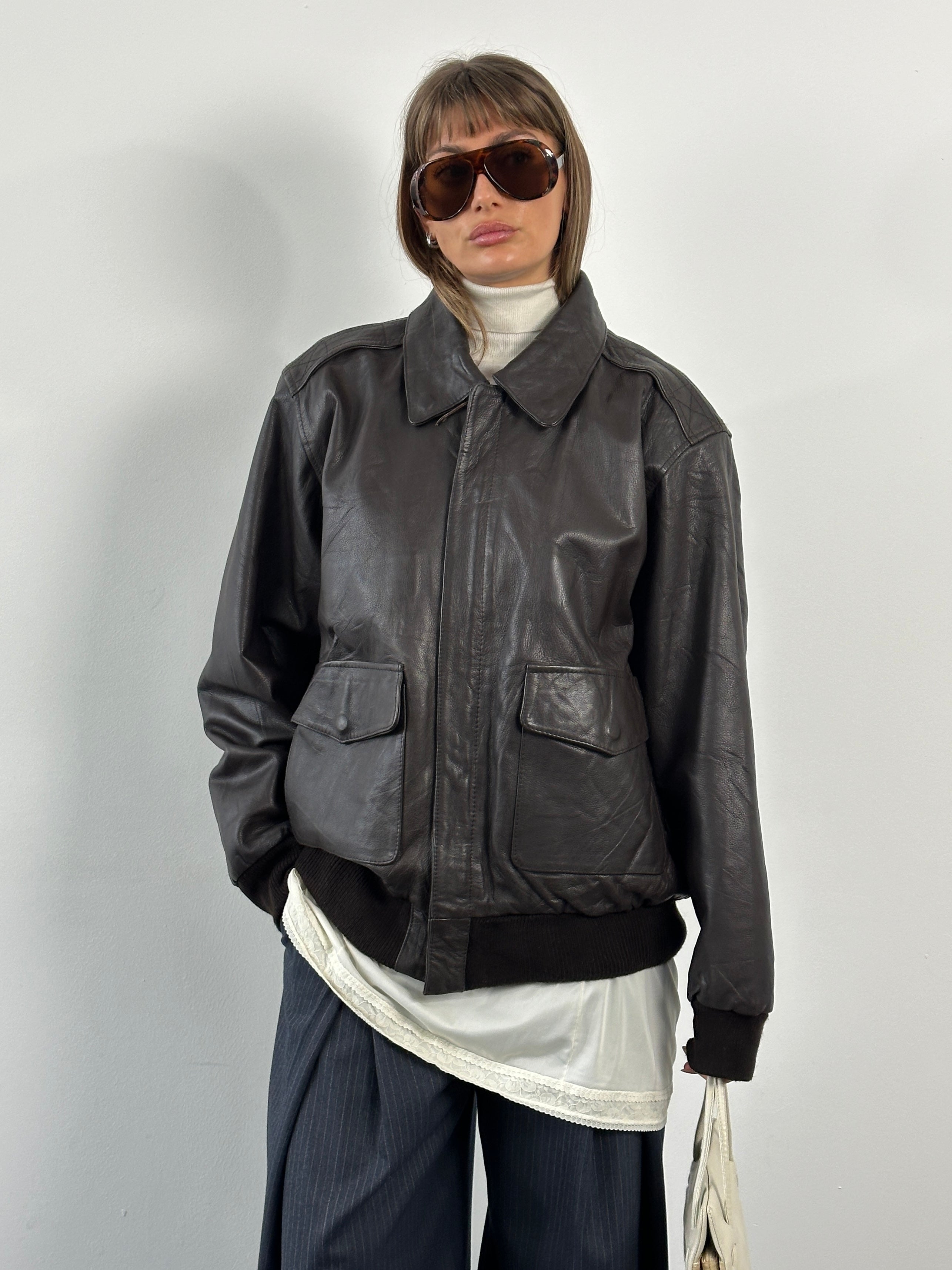 Vintage 1990s concealed placket bomber leather jacket in XL, black leather with classic design and vintage style details.