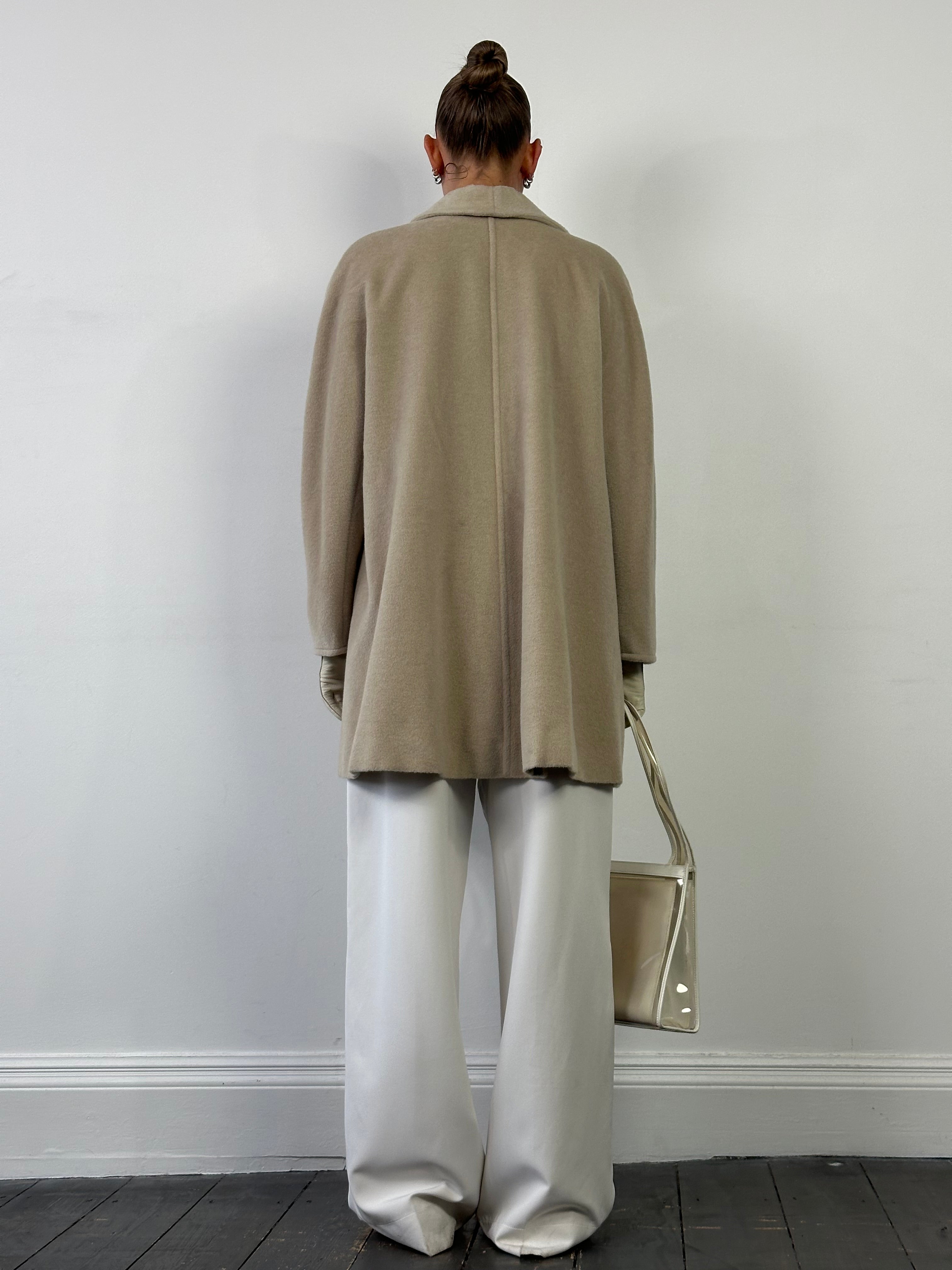 Max Mara brushed wool cashmere single-breasted coat in black, displayed hanging with lapel and button details visible.
