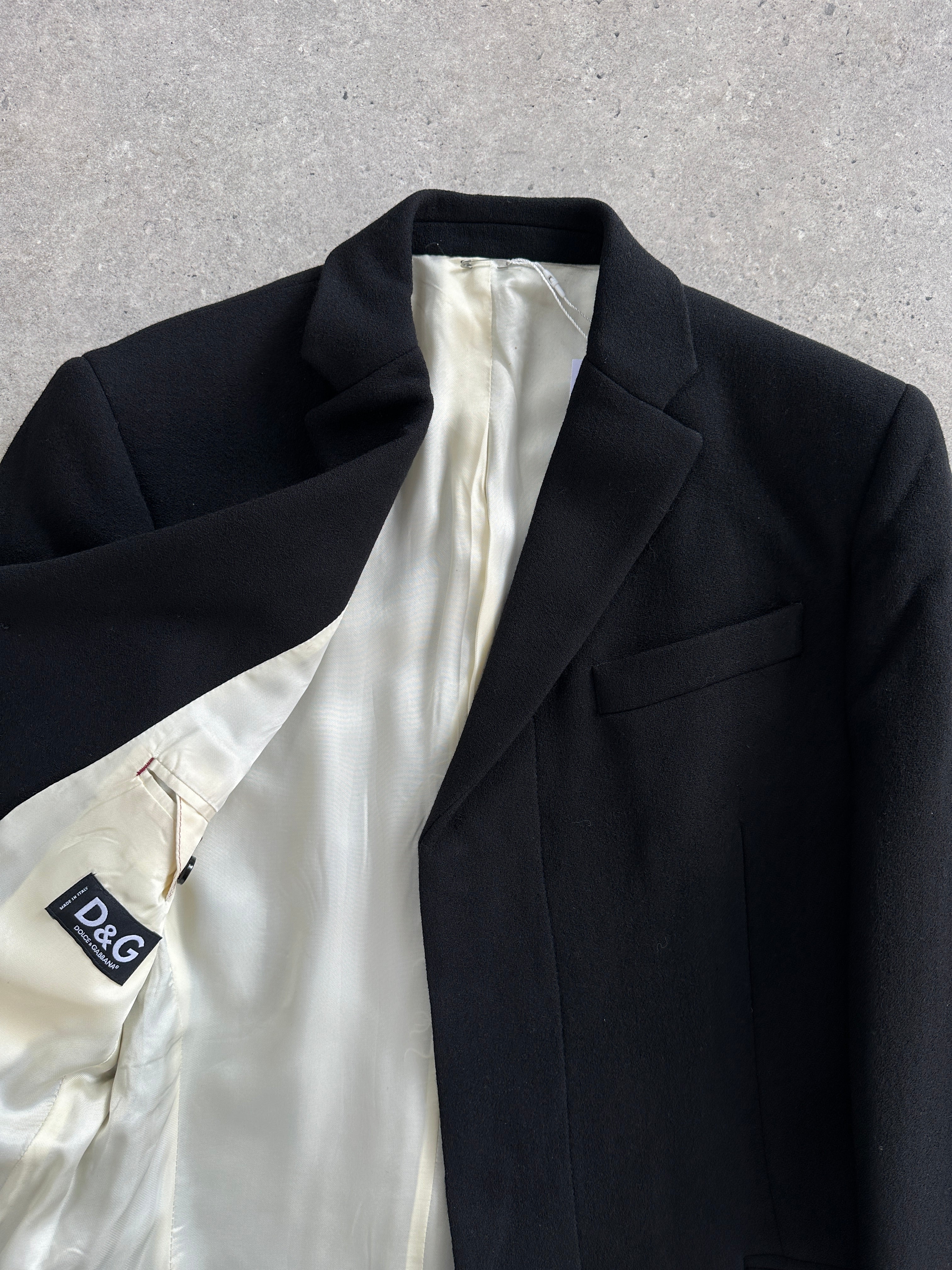 Dolce & Gabbana pure wool single-breasted coat in size M, shown hanging with a classic lapel collar and tailored fit.