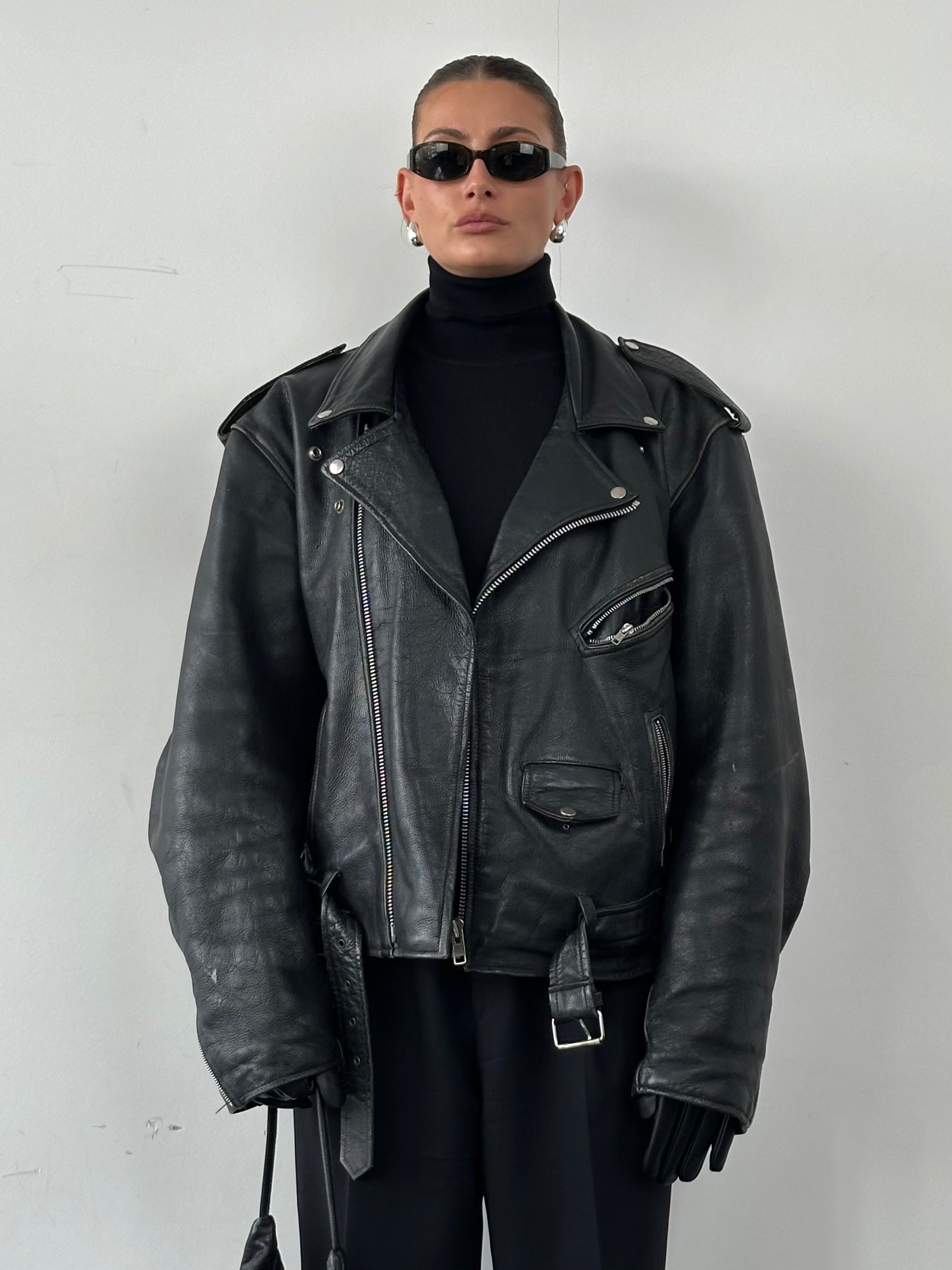 Vintage leather biker jacket in size XL, featuring classic design with rugged texture and metal zipper details.