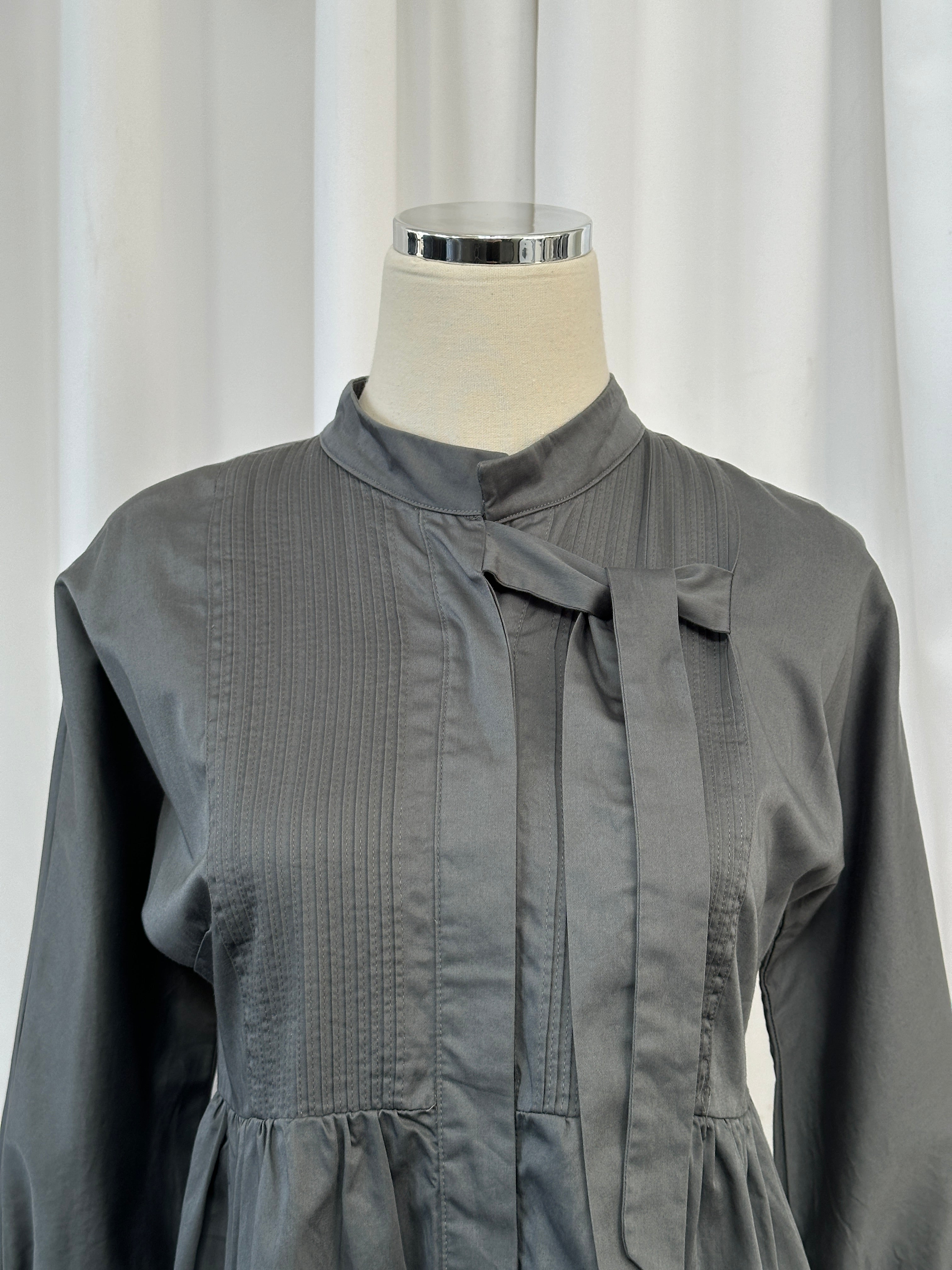 Vintage 2000s peplum cotton tie shirt in XS/S, featuring a fitted silhouette and retro style, displayed on a hanger.