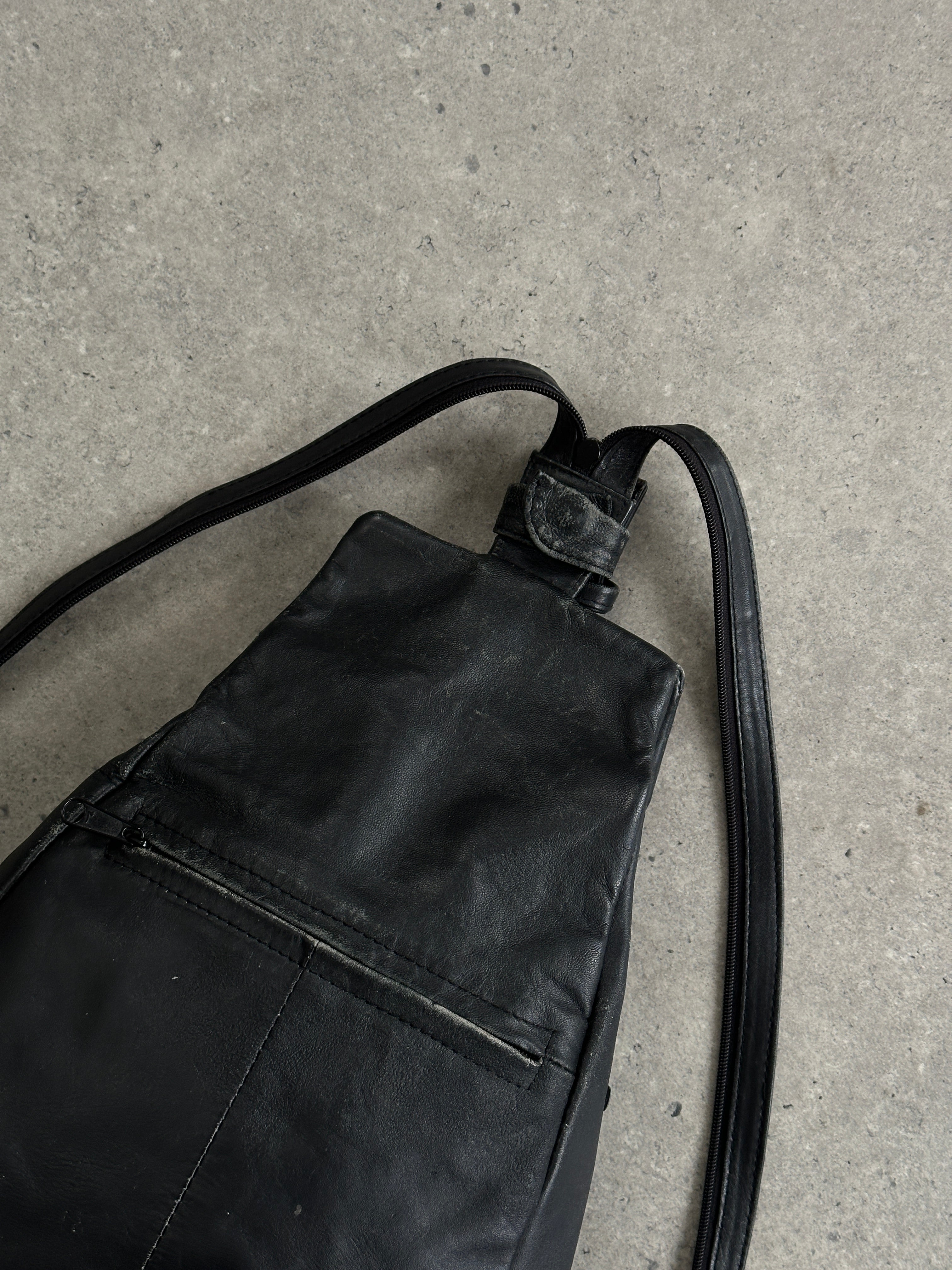 Vintage distressed faux leather rucksack crossbody bag with adjustable strap and vintage-style hardware, stylish and functional.