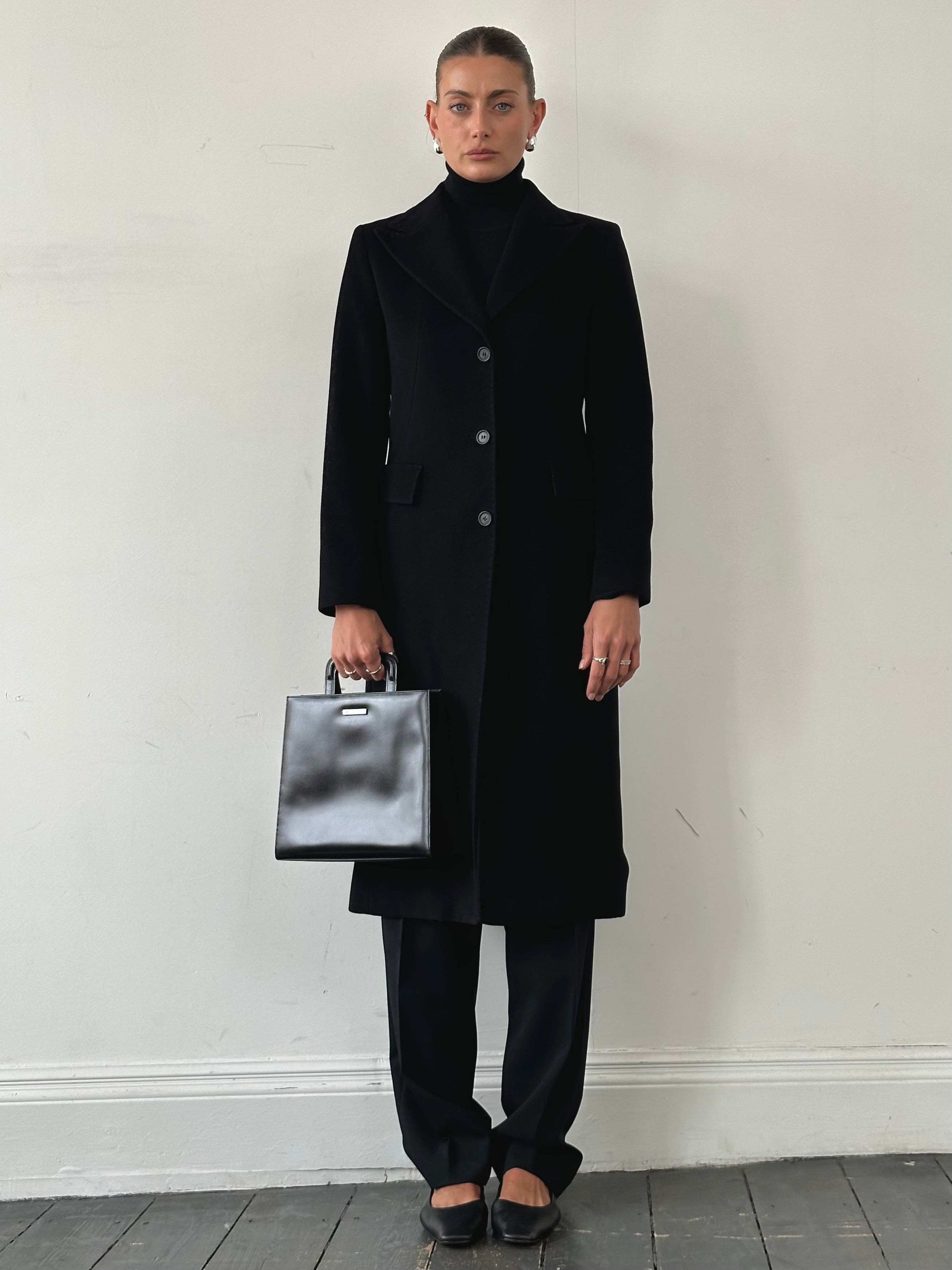 Max Mara pure wool single-breasted coat in classic design, shown in a natural pose highlighting its tailored fit and elegant style.