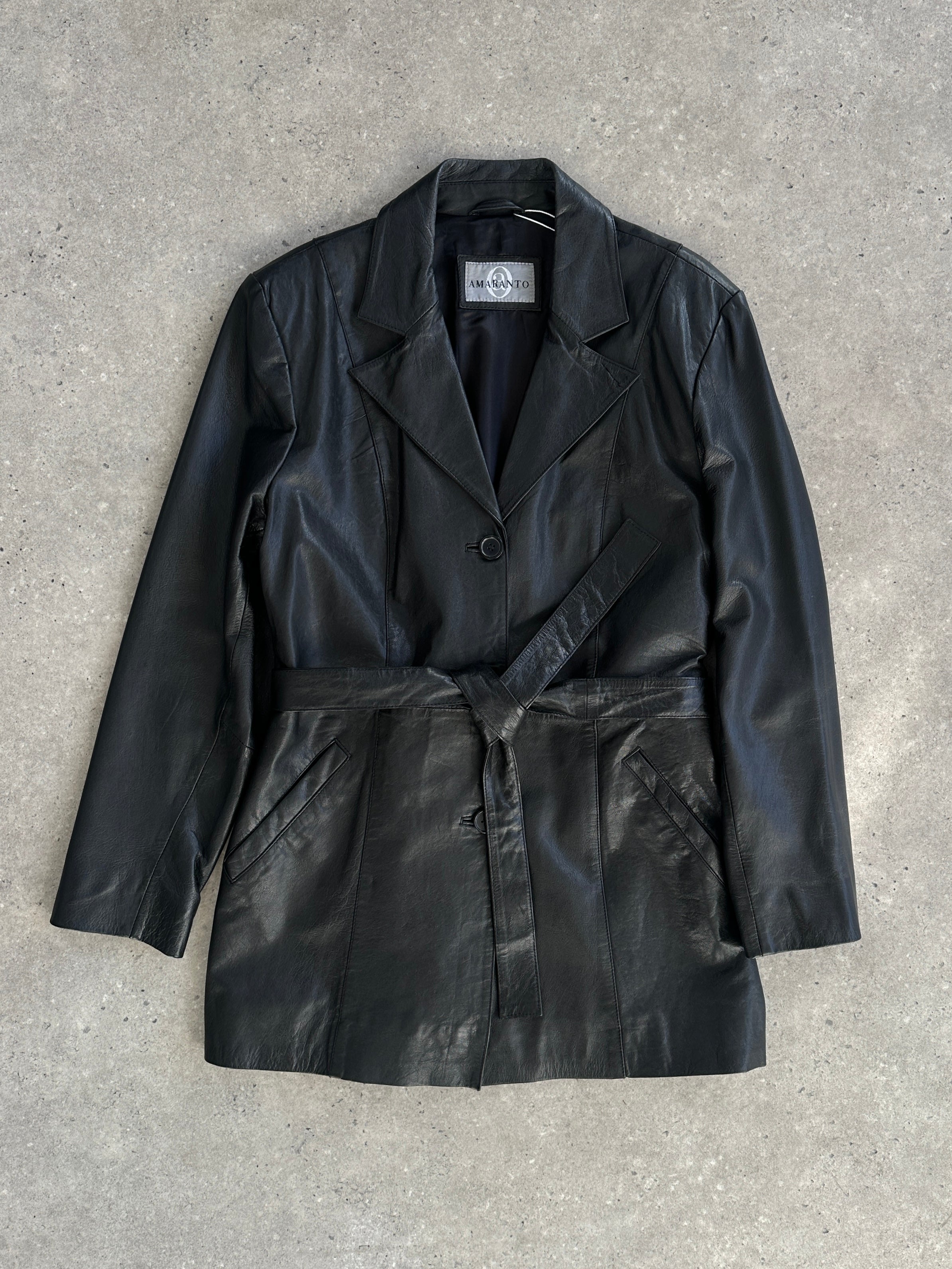 Vintage leather belted jacket in size M/L, featuring classic design and textured leather material, displayed on a neutral background.