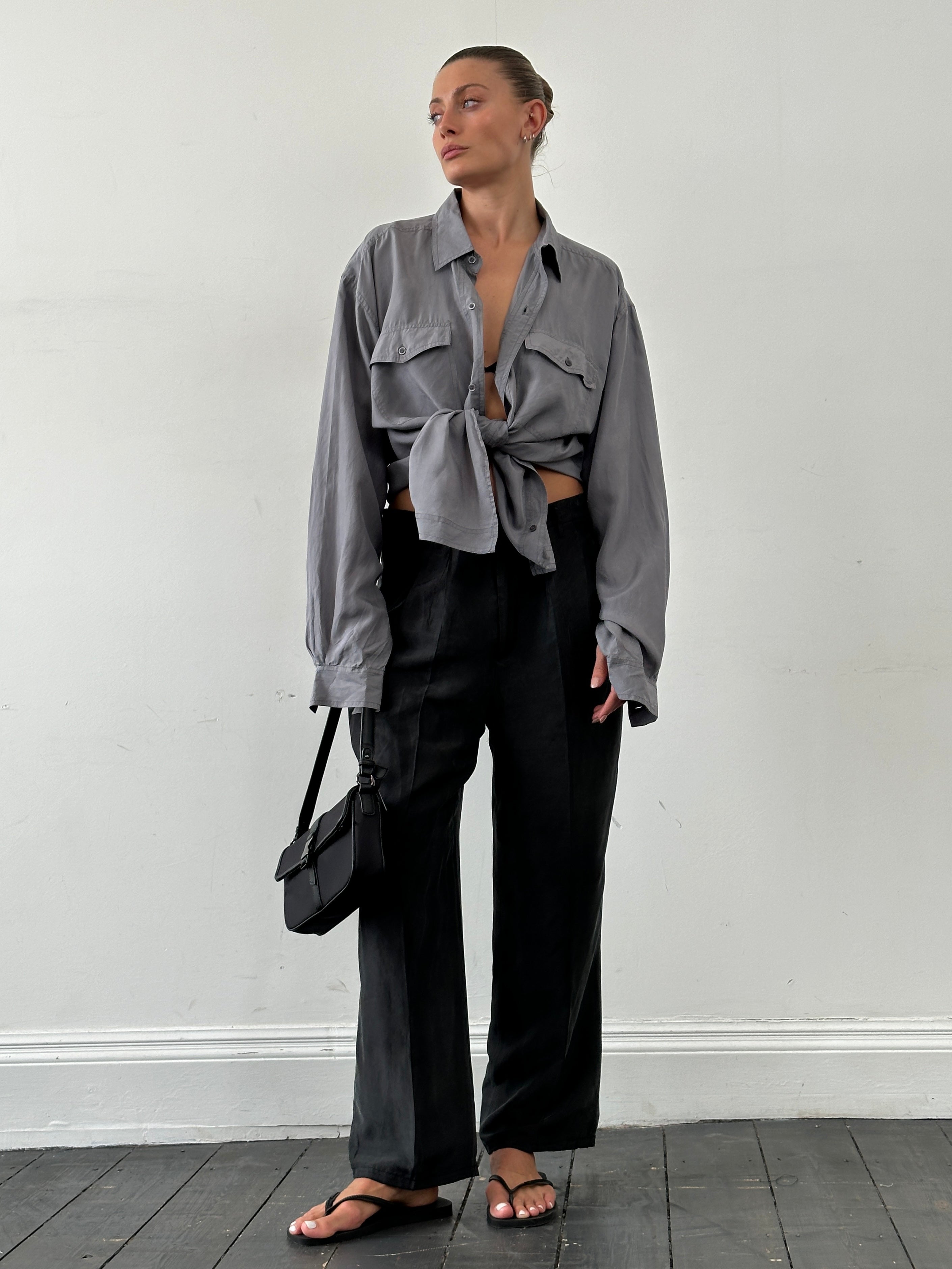 Vintage pure silk high-waisted straight leg trousers in W32, shown hanging with a smooth, elegant fit and classic style.