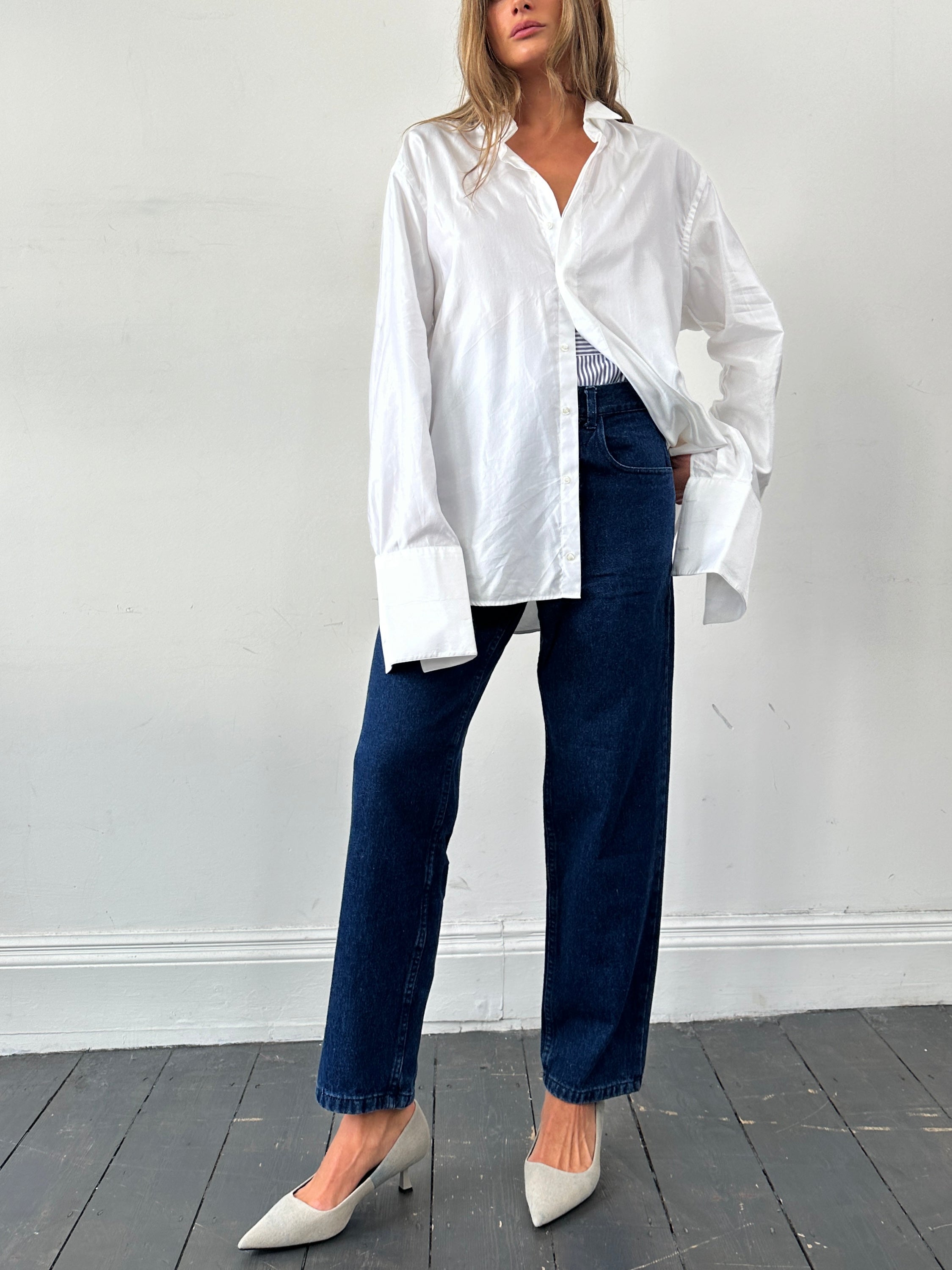 Vintage high-waisted straight-leg denim jeans in W30, shown on a hanger with a classic blue wash and vintage style.