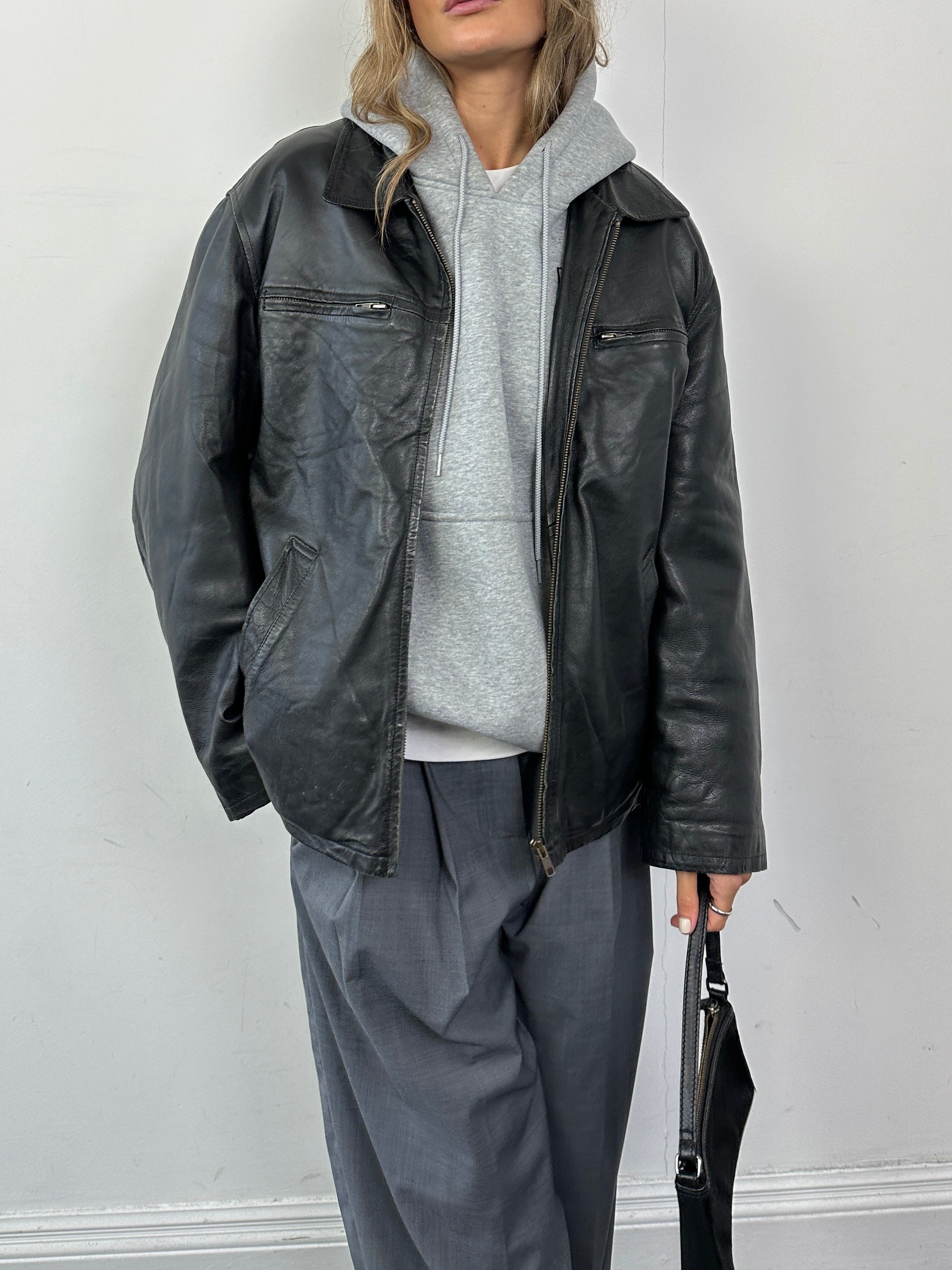 Conbipel zip-up leather jacket in size L, black, with a sleek design and visible front zipper, stylish and durable outerwear.