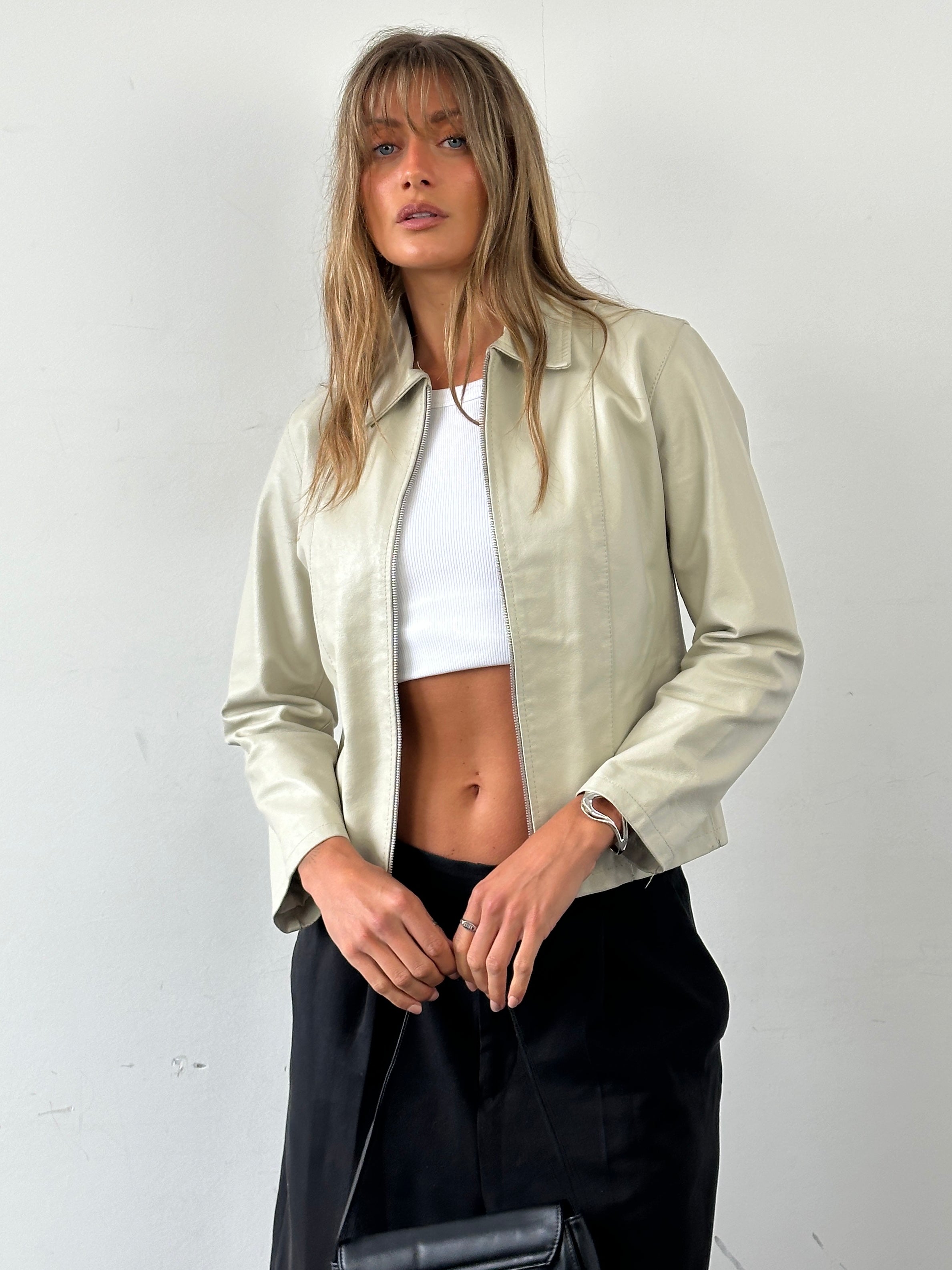 Vintage Italian leather zip-up jacket for women, classic vintage style with front zipper and leather texture.