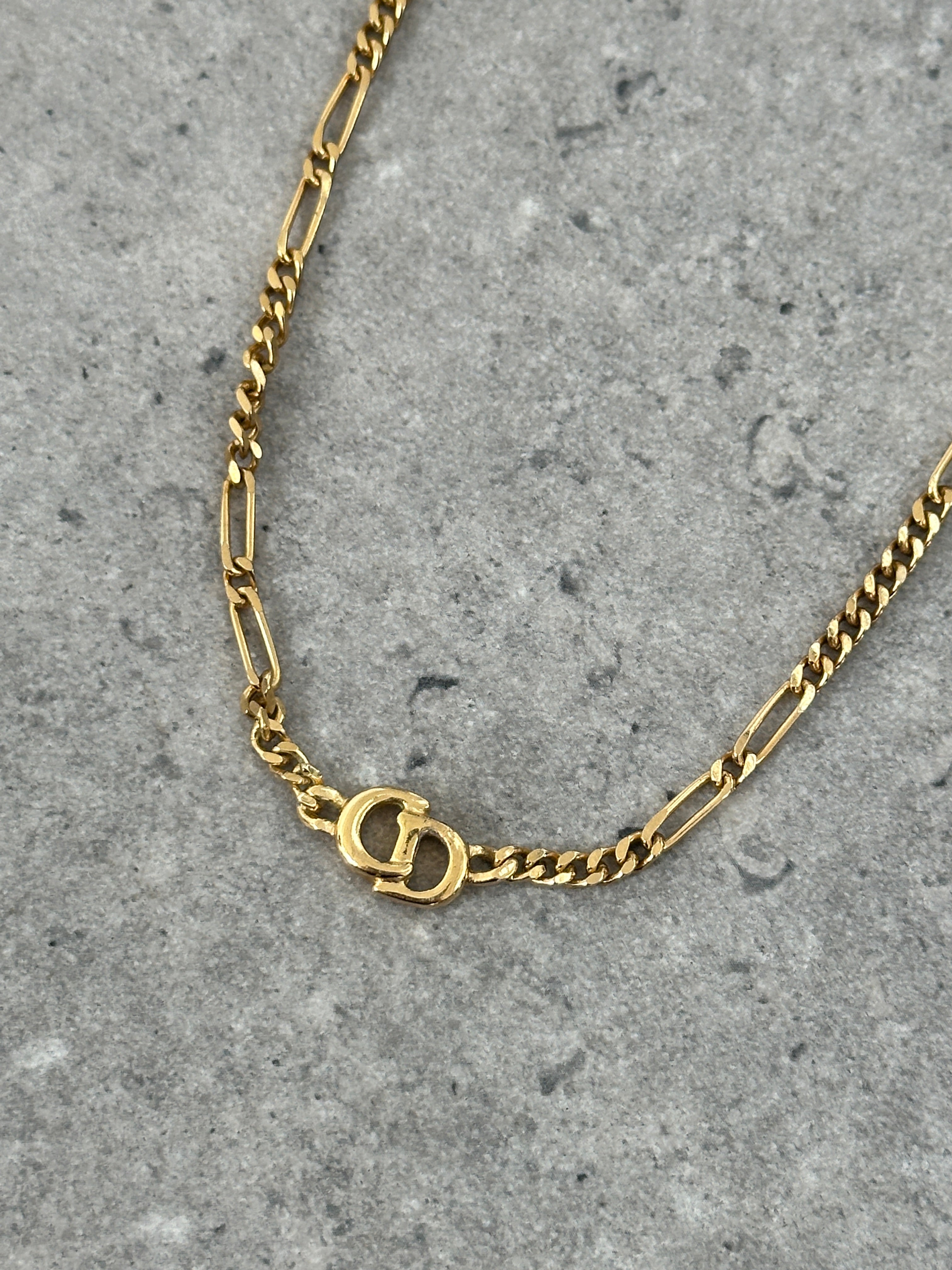 Christian Dior 18-inch gold-plated logo pendant necklace with elegant chain and signature Dior branding.