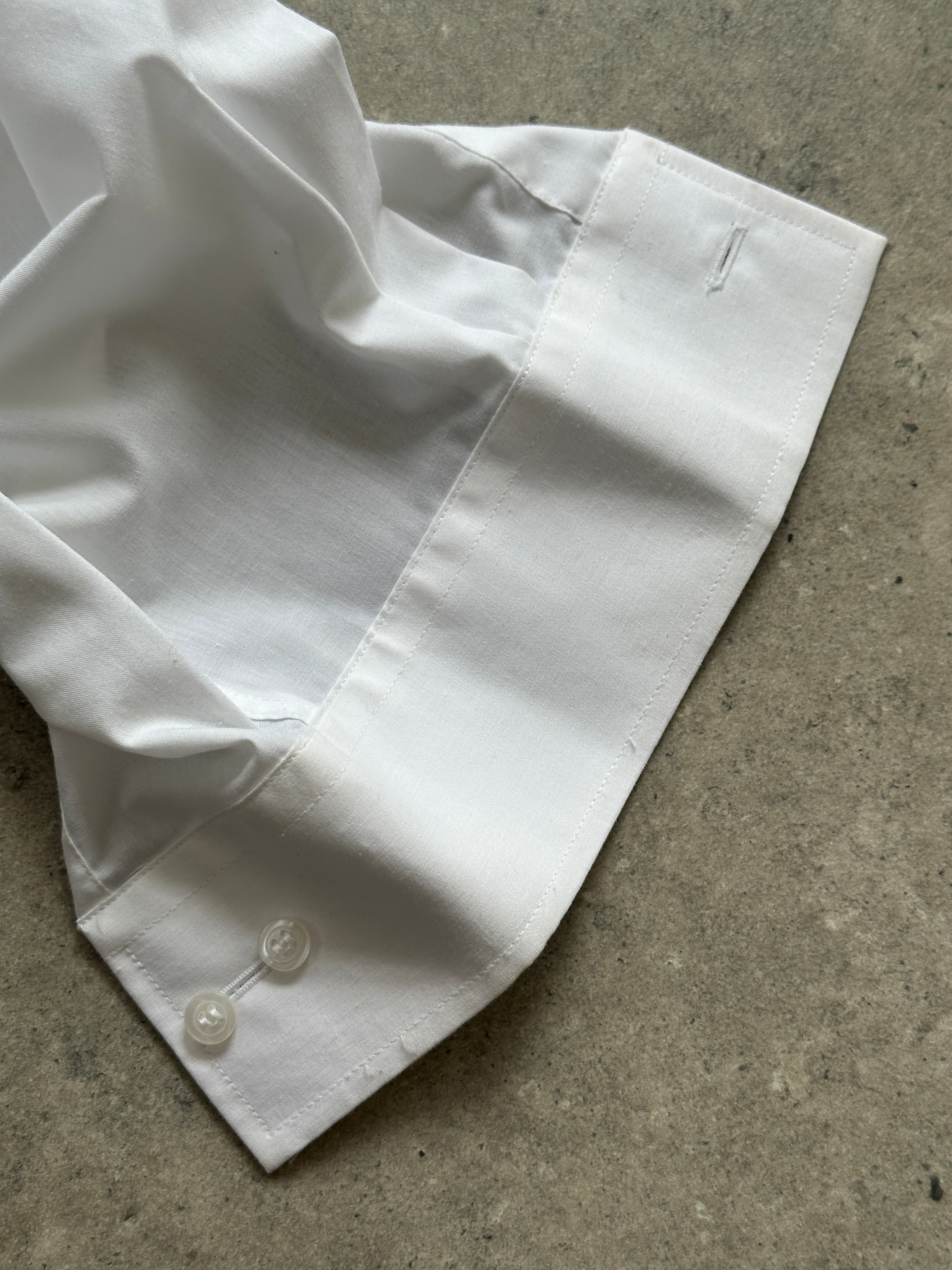 Vintage cotton pleated tuxedo dress shirt in XL, featuring classic pleats and a tailored fit, displayed on a hanger.