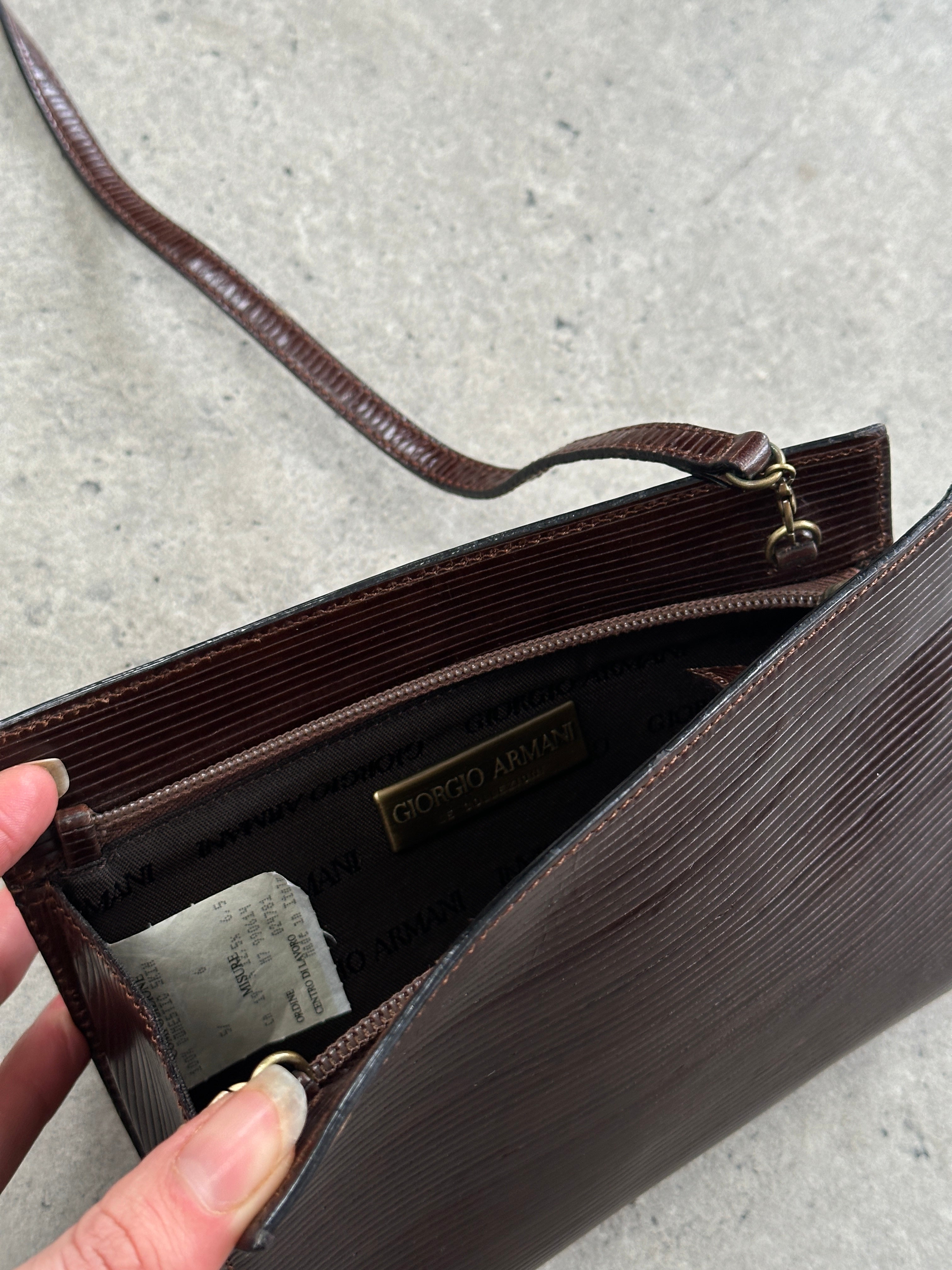 Giorgio Armani Le Collezioni 1990s leather crossbody bag with adjustable strap and classic design, in a rich brown color.