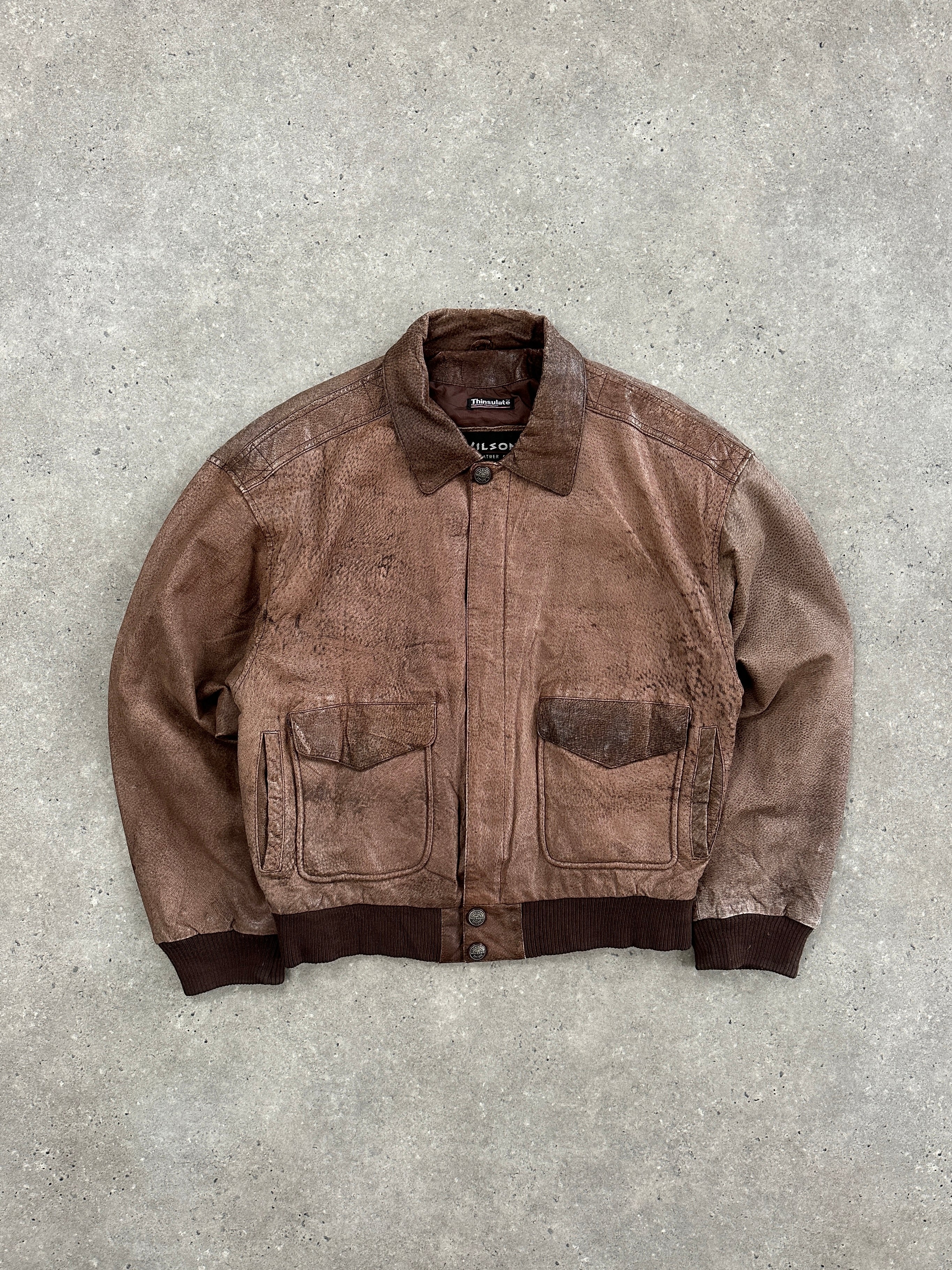 Vintage 1990s leather bomber jacket, size large, featuring classic design and brown leather material.