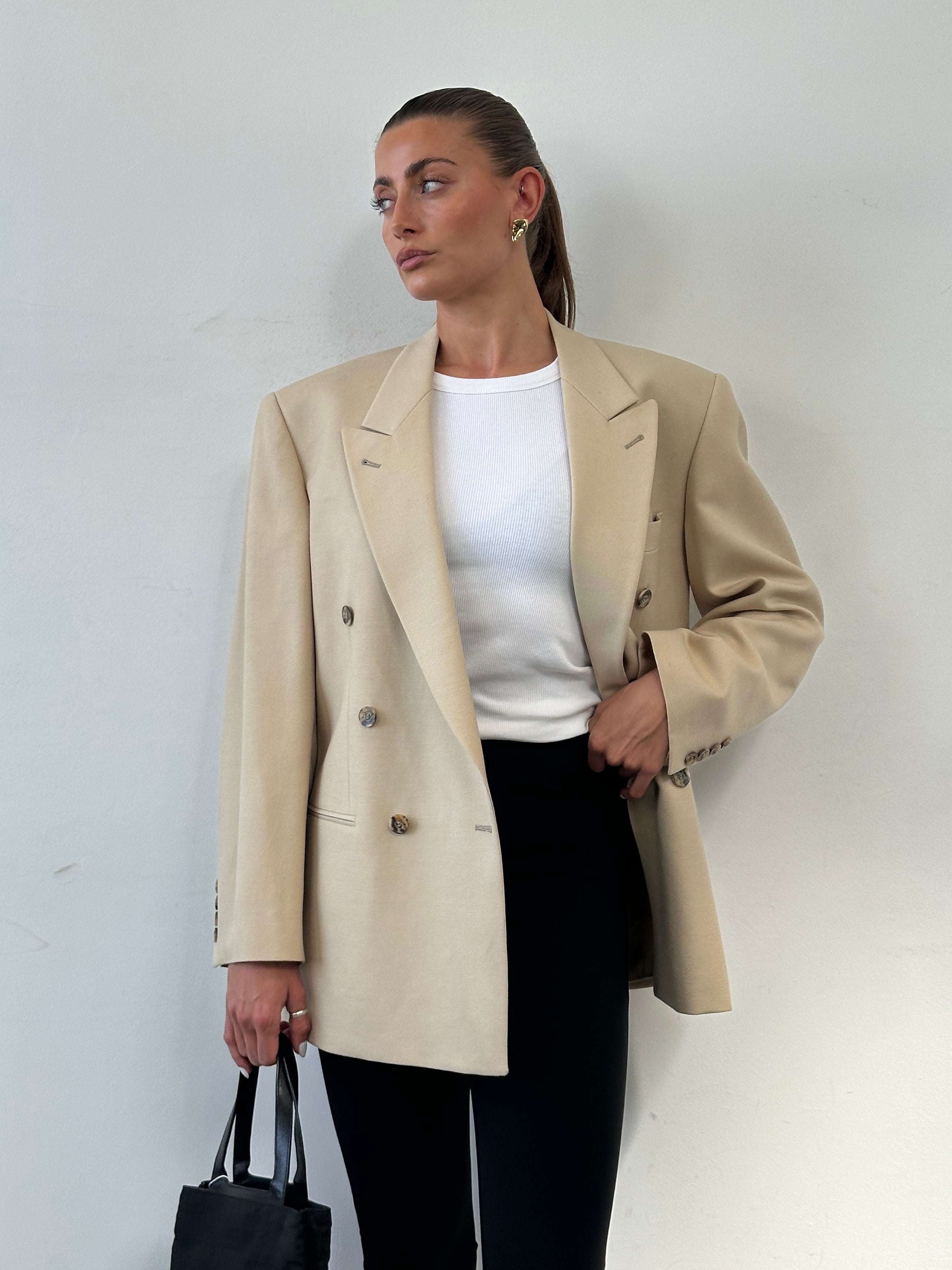 Vintage wool double-breasted blazer in size 40R/L, featuring classic tailored design and rich fabric details.